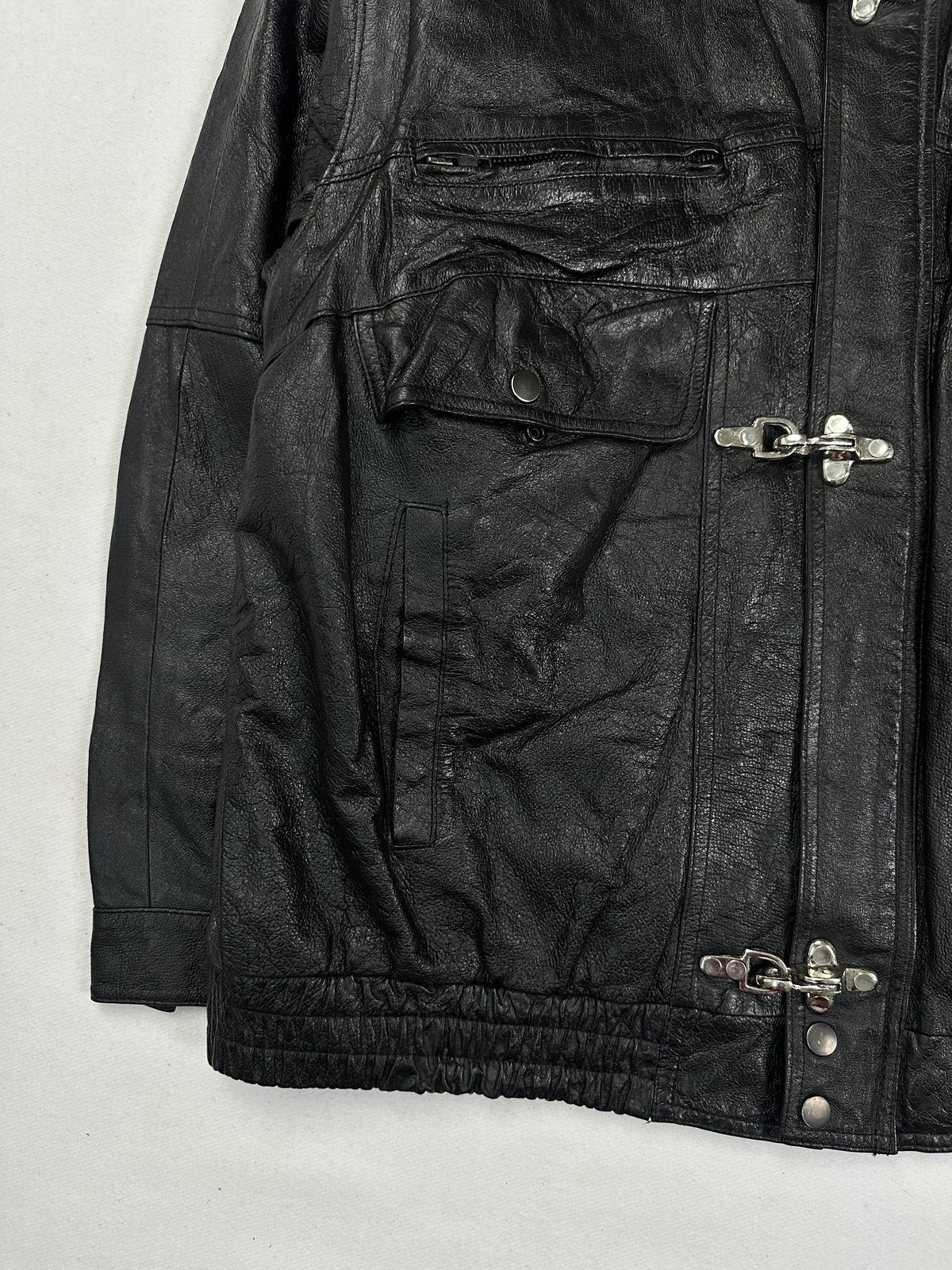 Wide collar sitting open at the neck of the black leather jacket