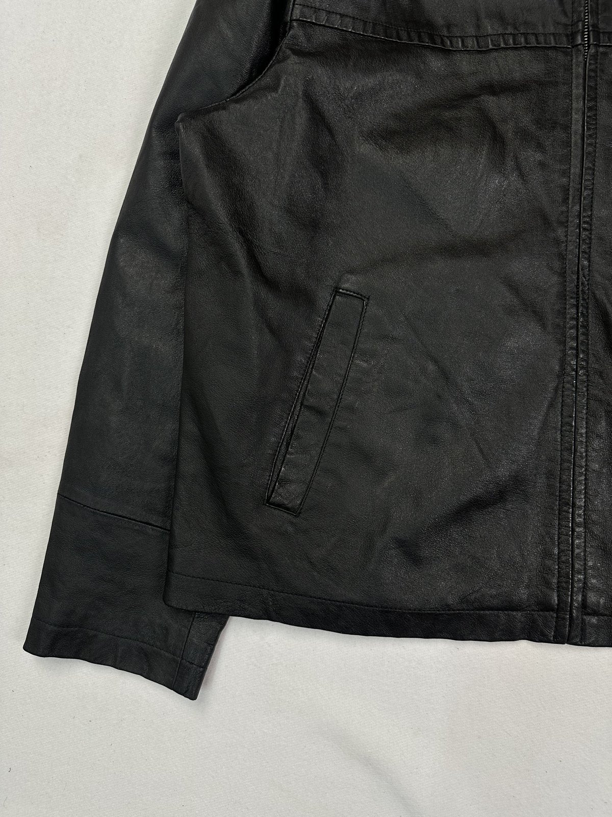 Lower front detail with a welt hand pocket set above the straight hem