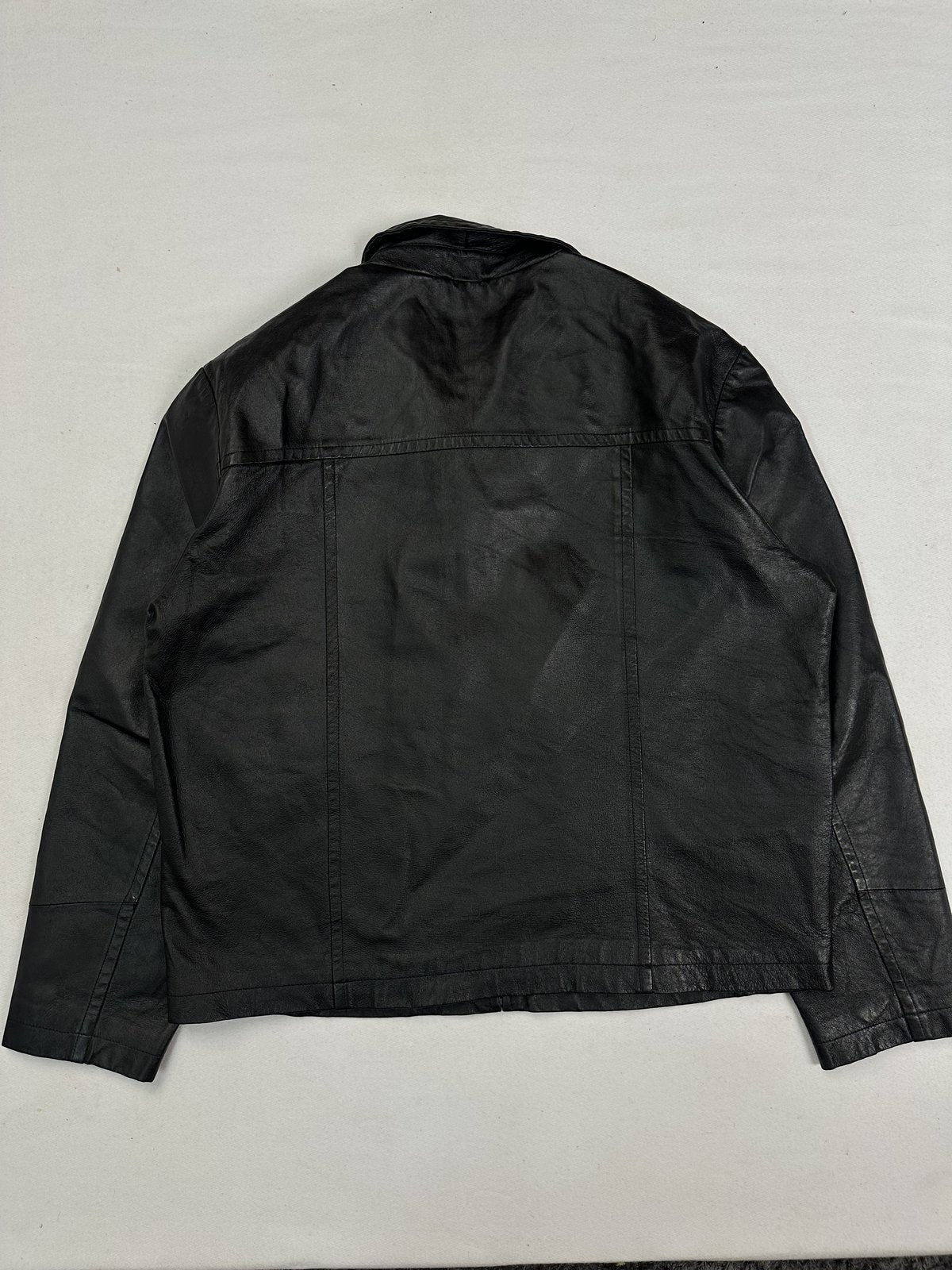 Back of the XL black harrington laid flat with its yoke seam