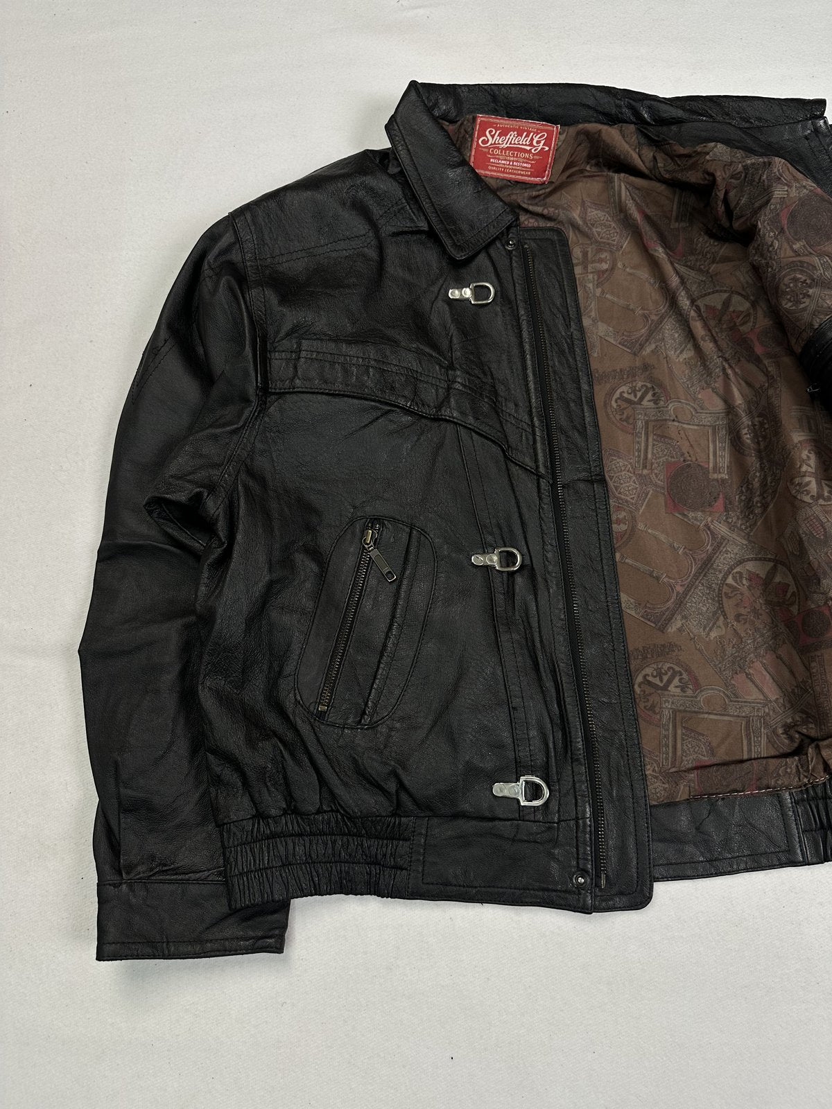 Padded panelling across the front of this size XL black leather jacket