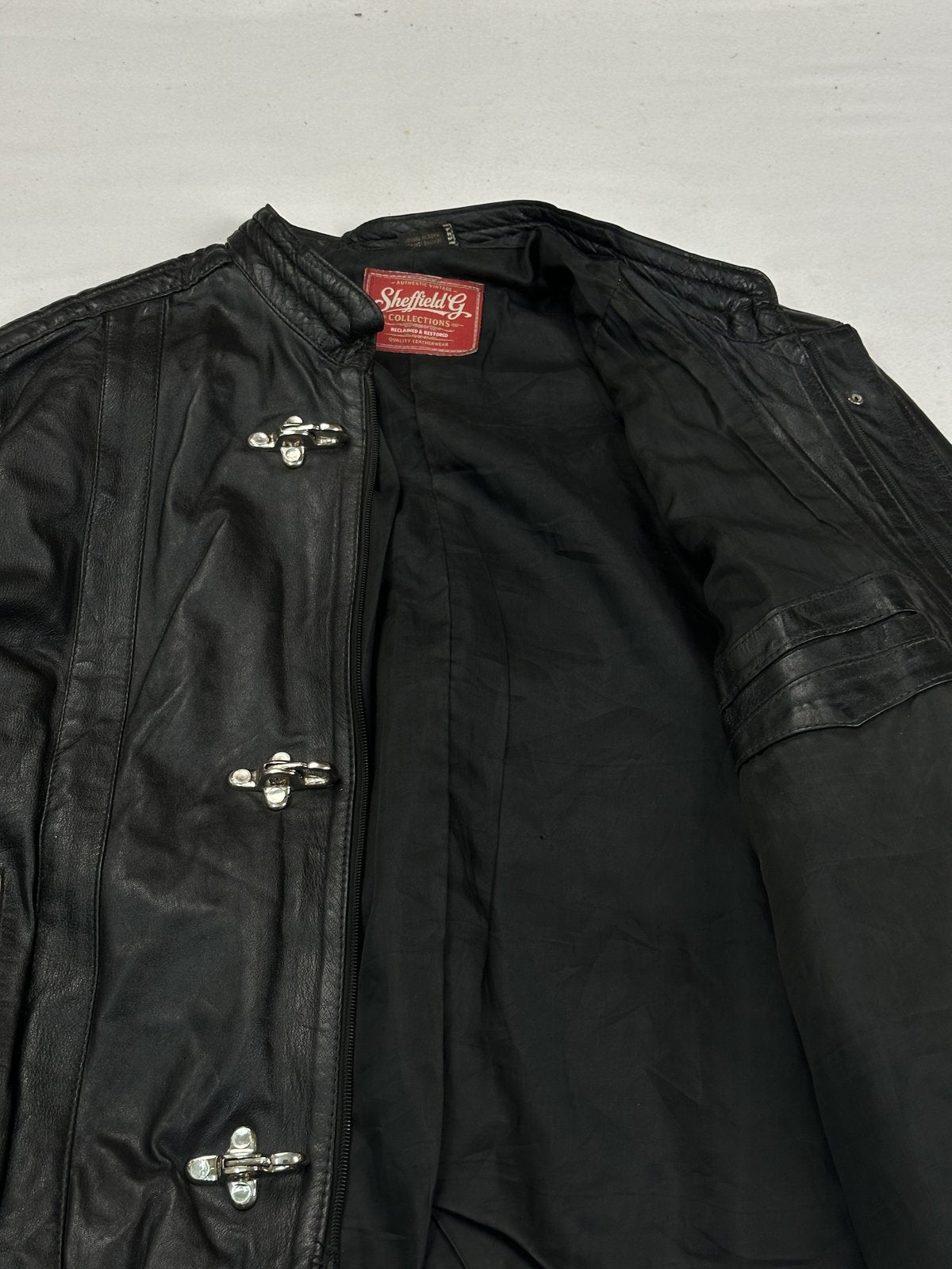 Full cut black leather blouson in size XXL with a 23 inch waist