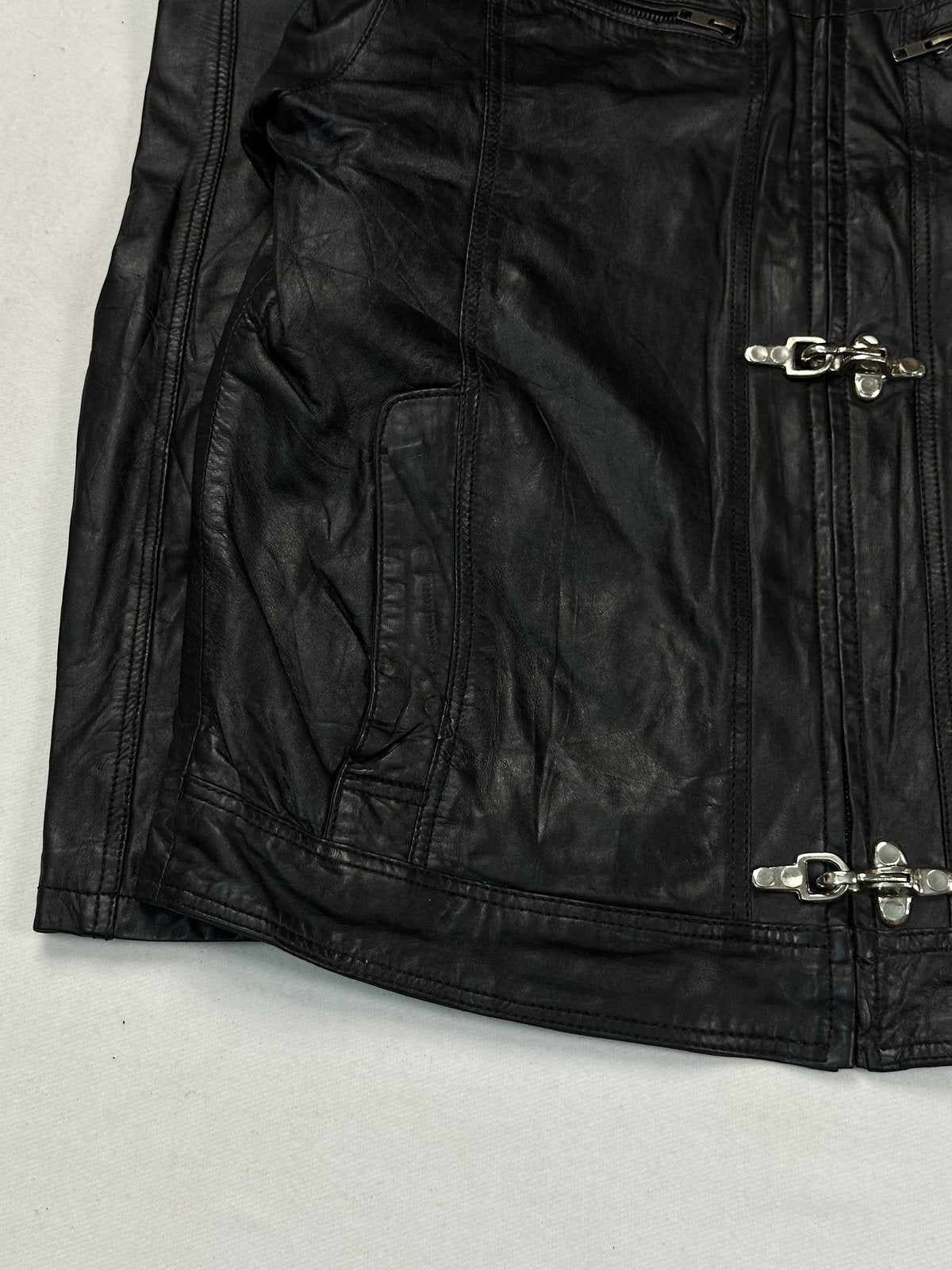 Lower front with a slash hand pocket, silver hook clasp and the straight hem