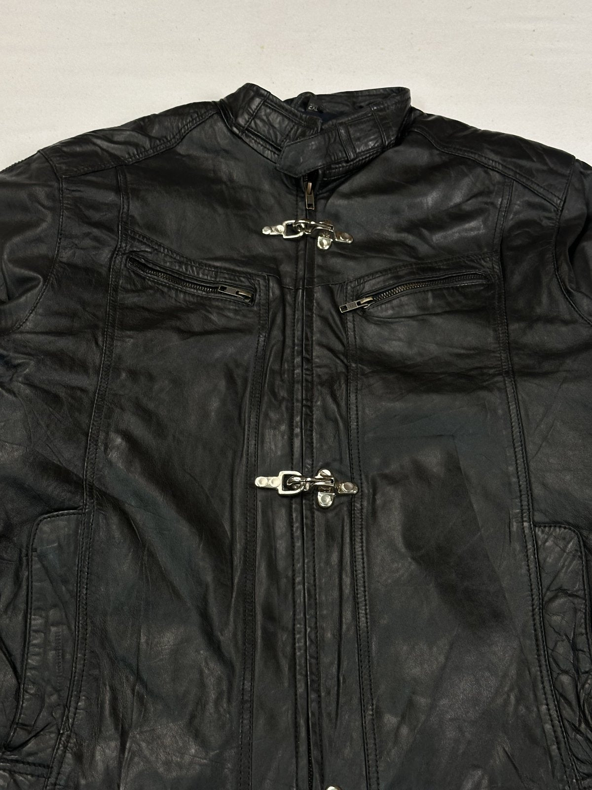 Close view of the mandarin collar above the centre zip and the top hook clasp