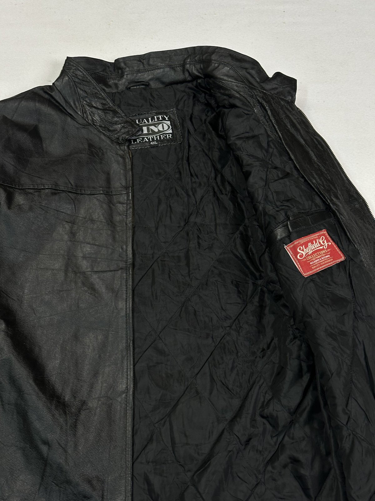 Broad shouldered black leather cafe racer jacket in size XL