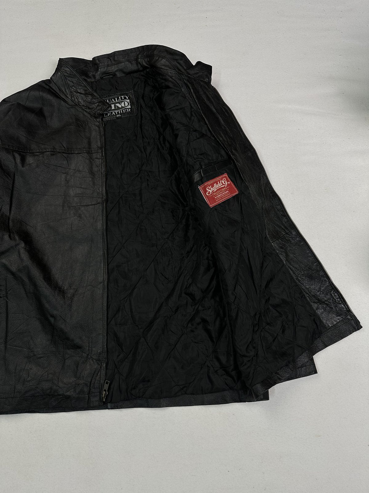 Black real leather cafe racer with a 22 inch sleeve, size XL