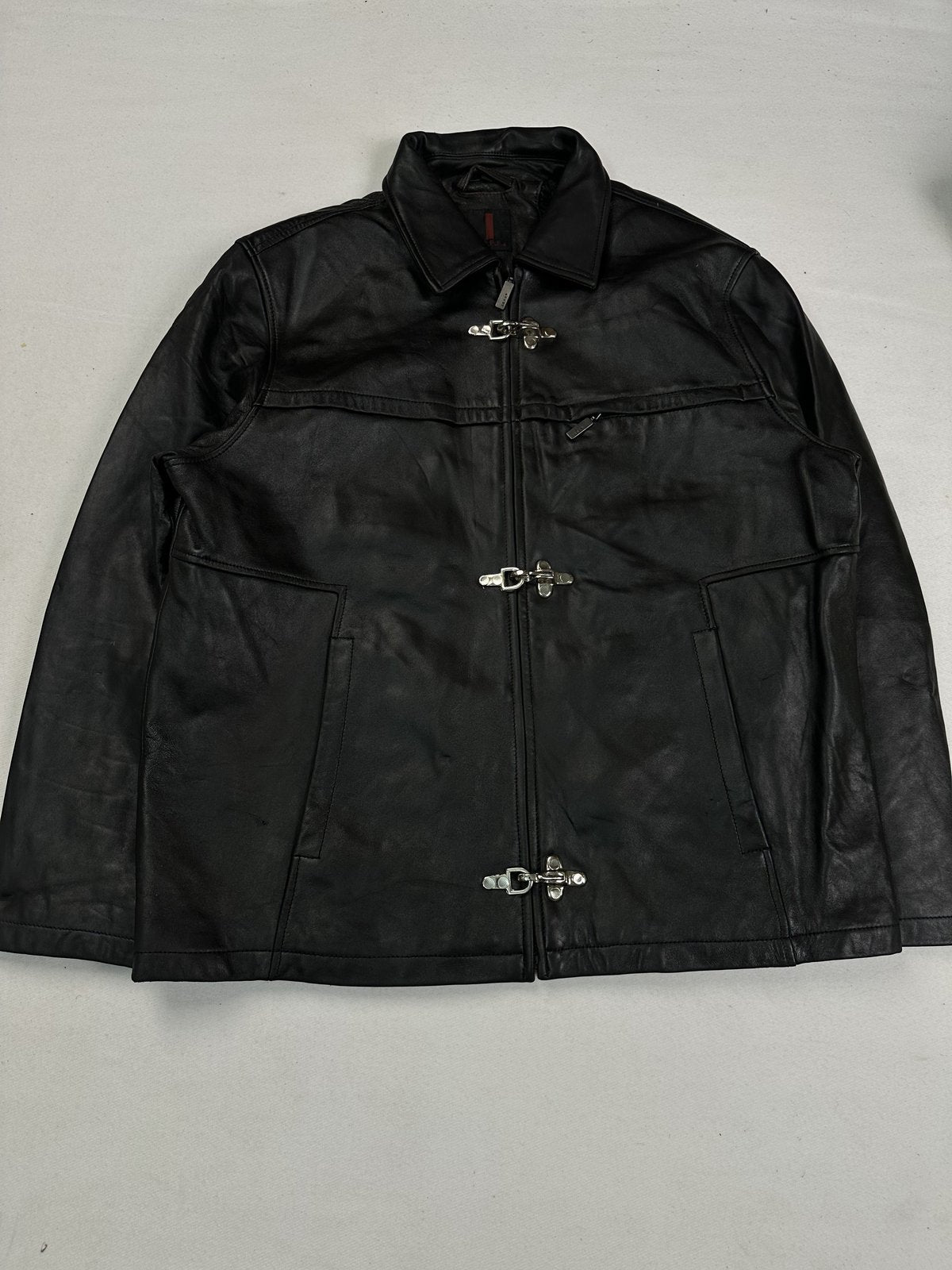 Black leather jacket in size XL with buckle clasps down the front