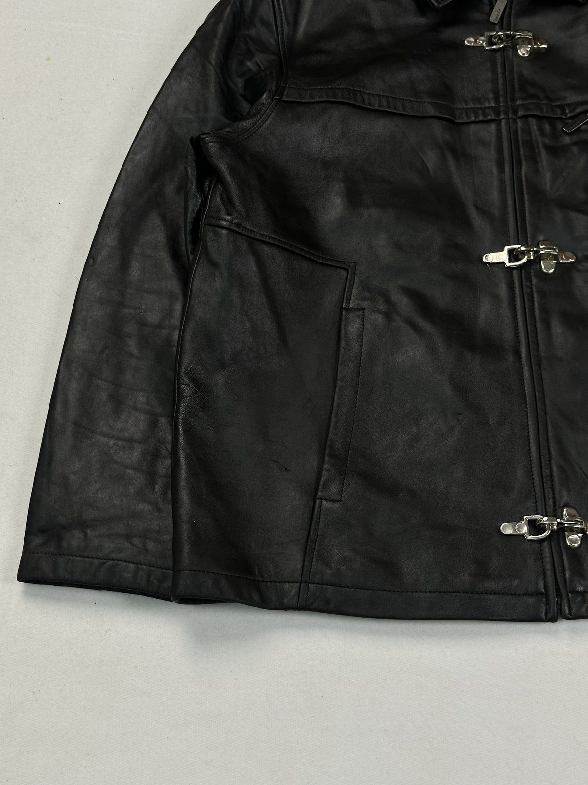 Yoke seam crossing the chest of the black leather jacket