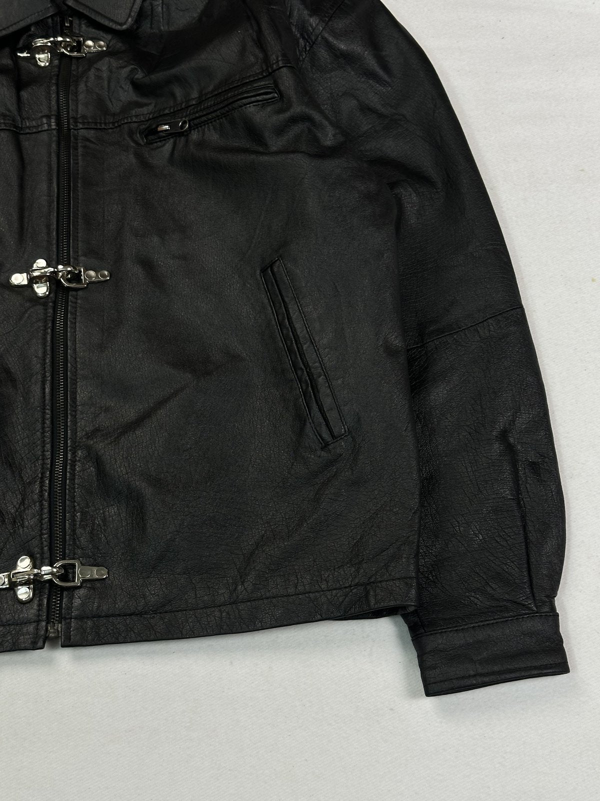 Angled view of the zipped chest pocket and slanted hand pocket beside the front zip