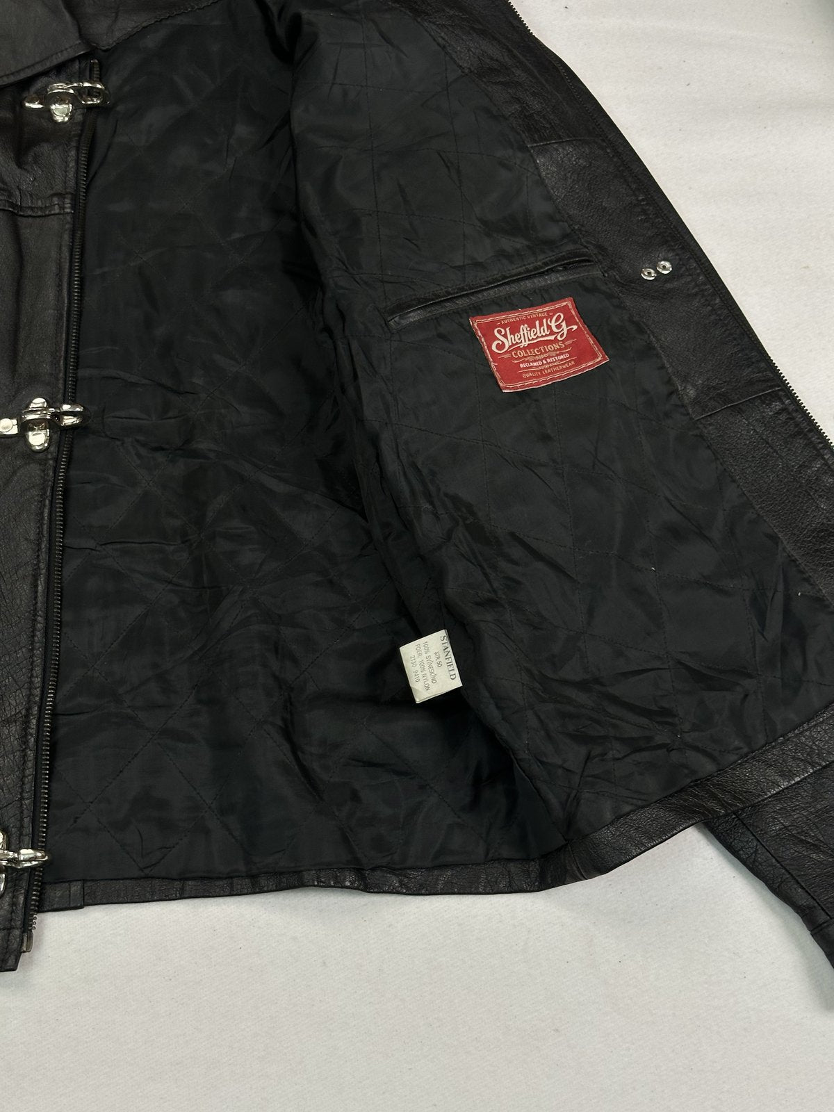 Smooth black lining inside the vintage jacket with an inner pocket, held open to view