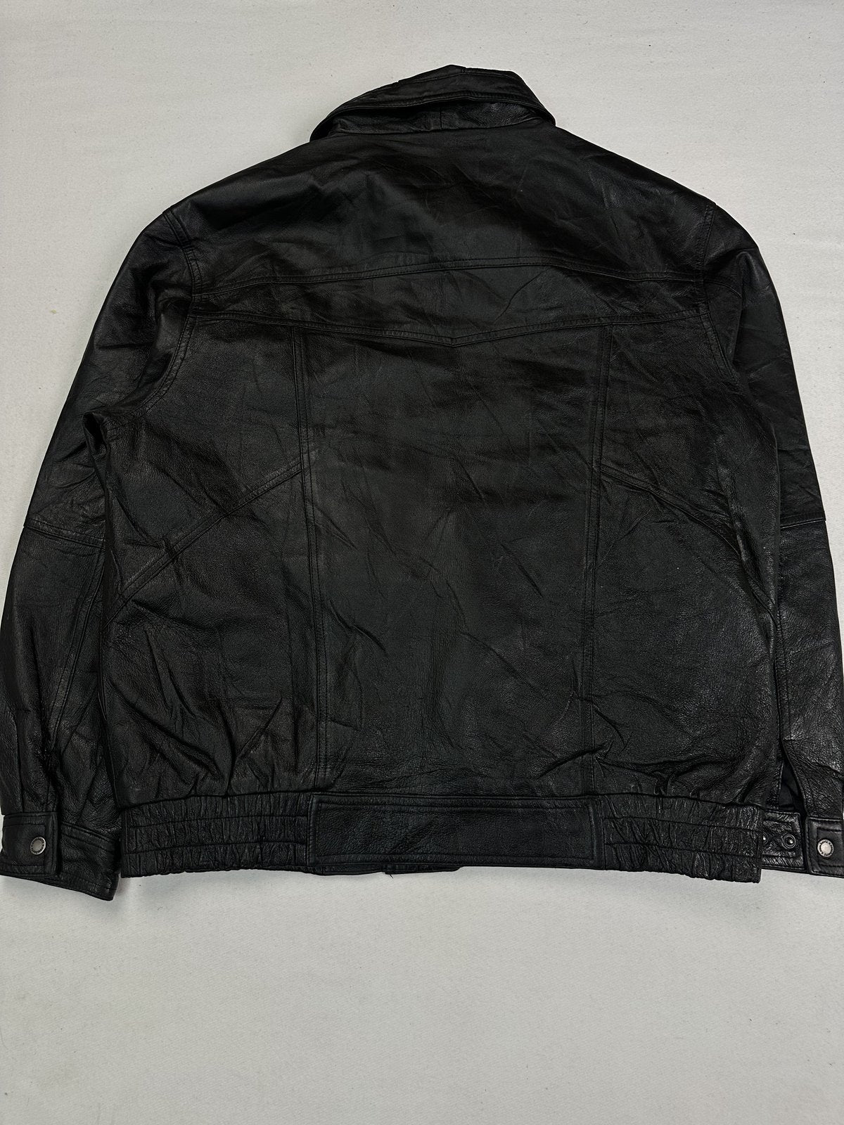 Back of the XXL black jacket laid flat showing the plain panel and elasticated waistband