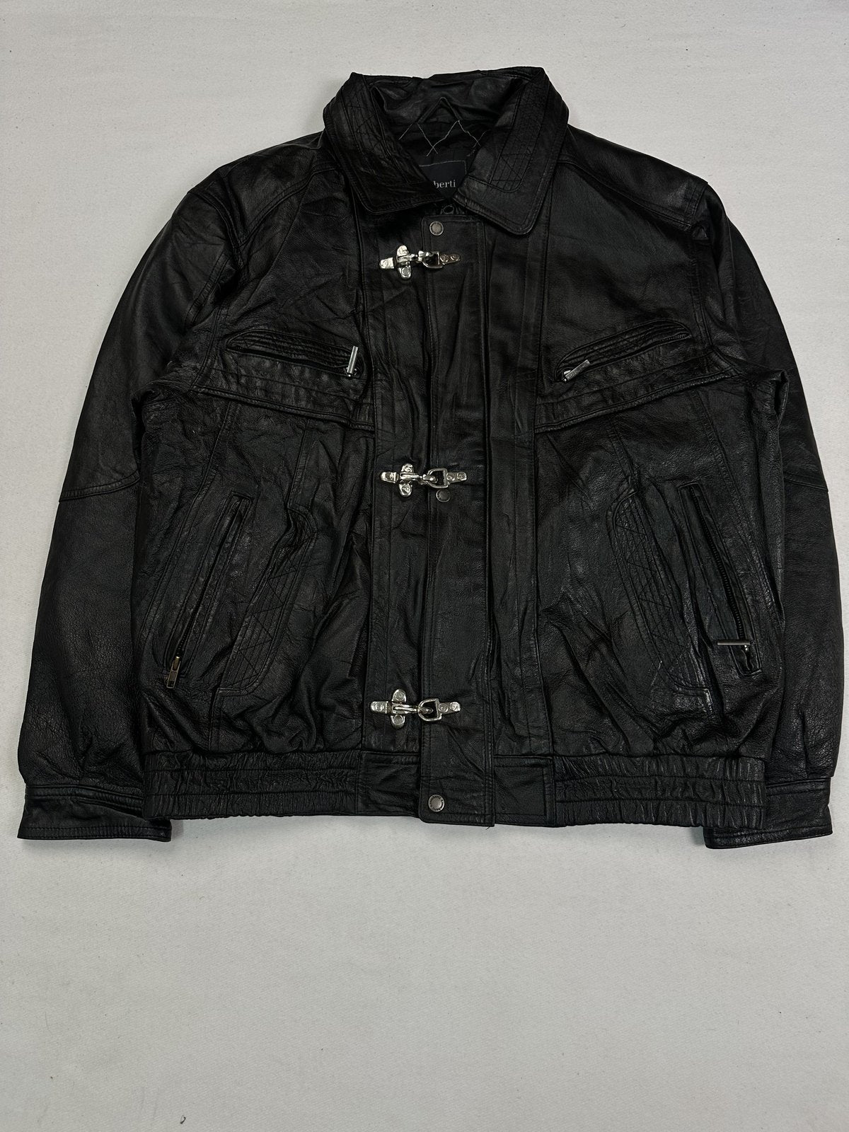 Black leather vintage jacket in size XXL shown from the front with quilted zip pockets