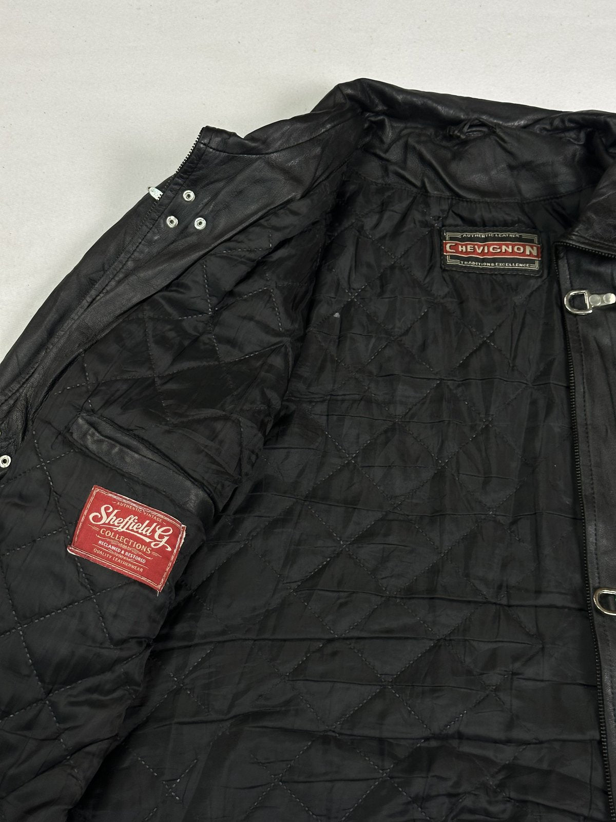 Utility styled black leather jacket in size L with a zipped front
