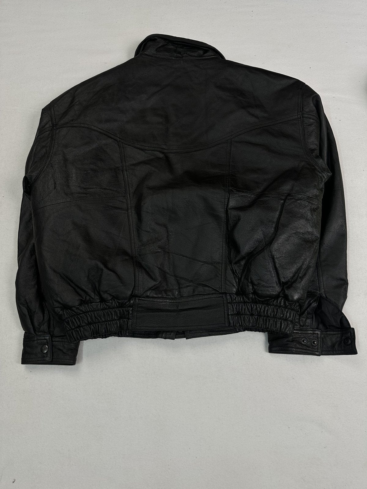 Snap flap chest pocket on the black leather jacket