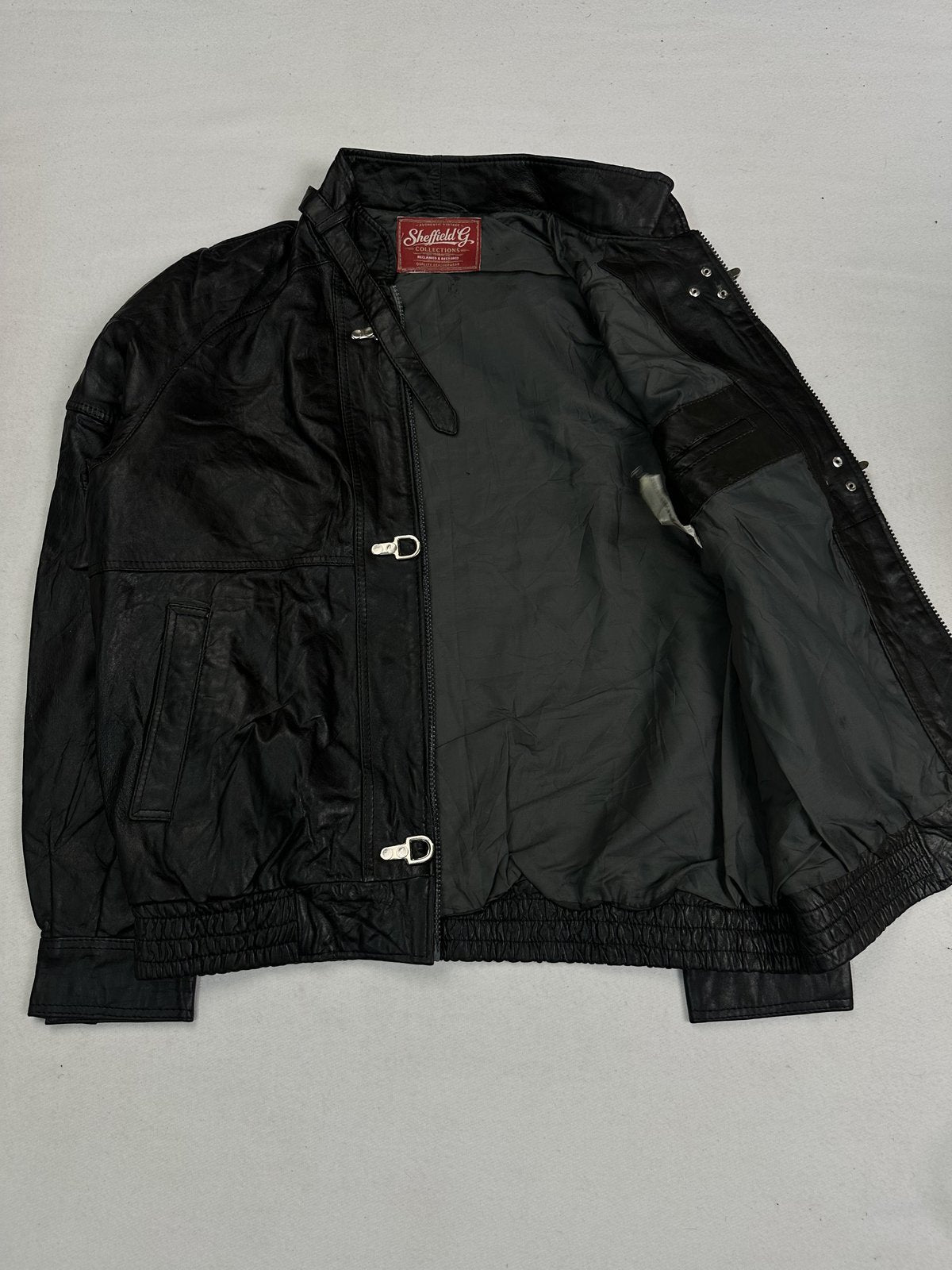 Cropped black leather jacket in size L with a 22 inch shoulder