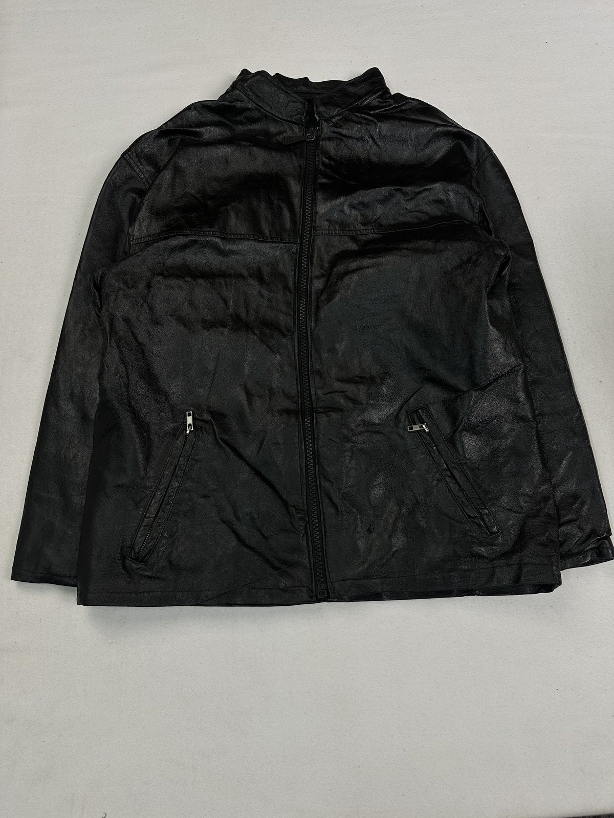 Black leather cafe racer jacket in size L with diagonal zip pockets