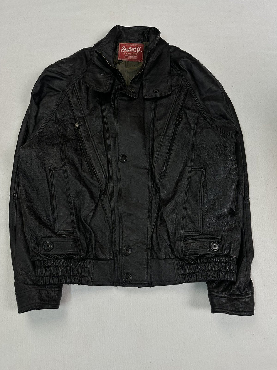 Black leather bomber jacket in size L shown from the front with its snap placket and 80s cut