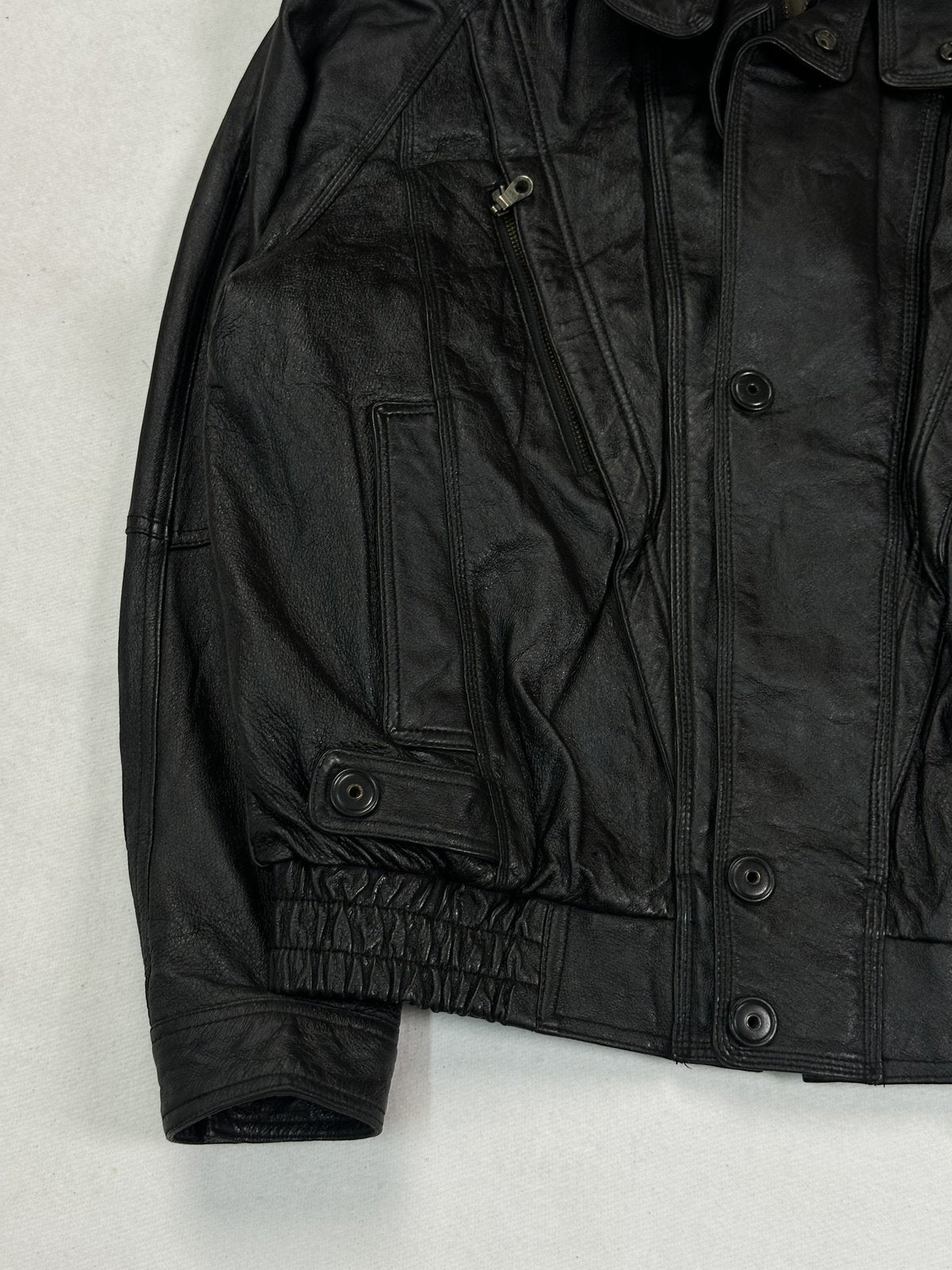 Lower left front with a welt pocket, snap tab and the shirred waistband