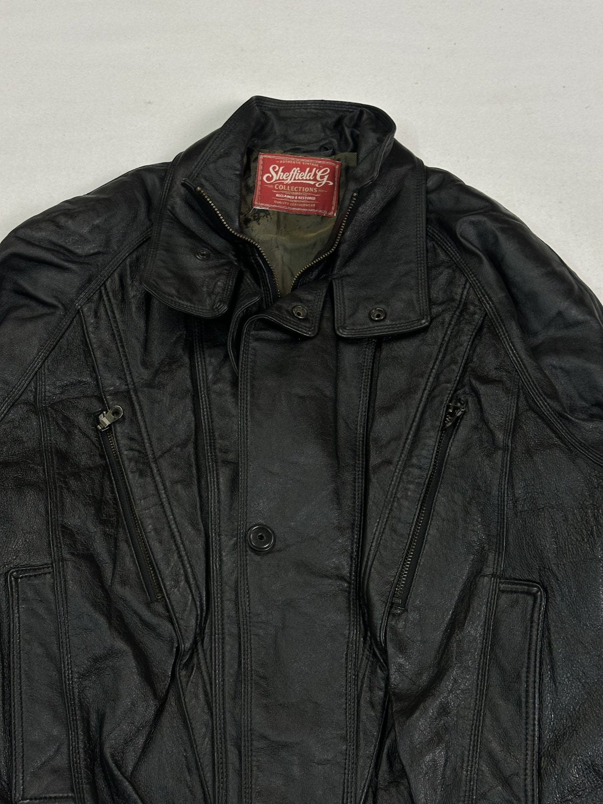Close view of the stand collar and the snap studs running down the front placket