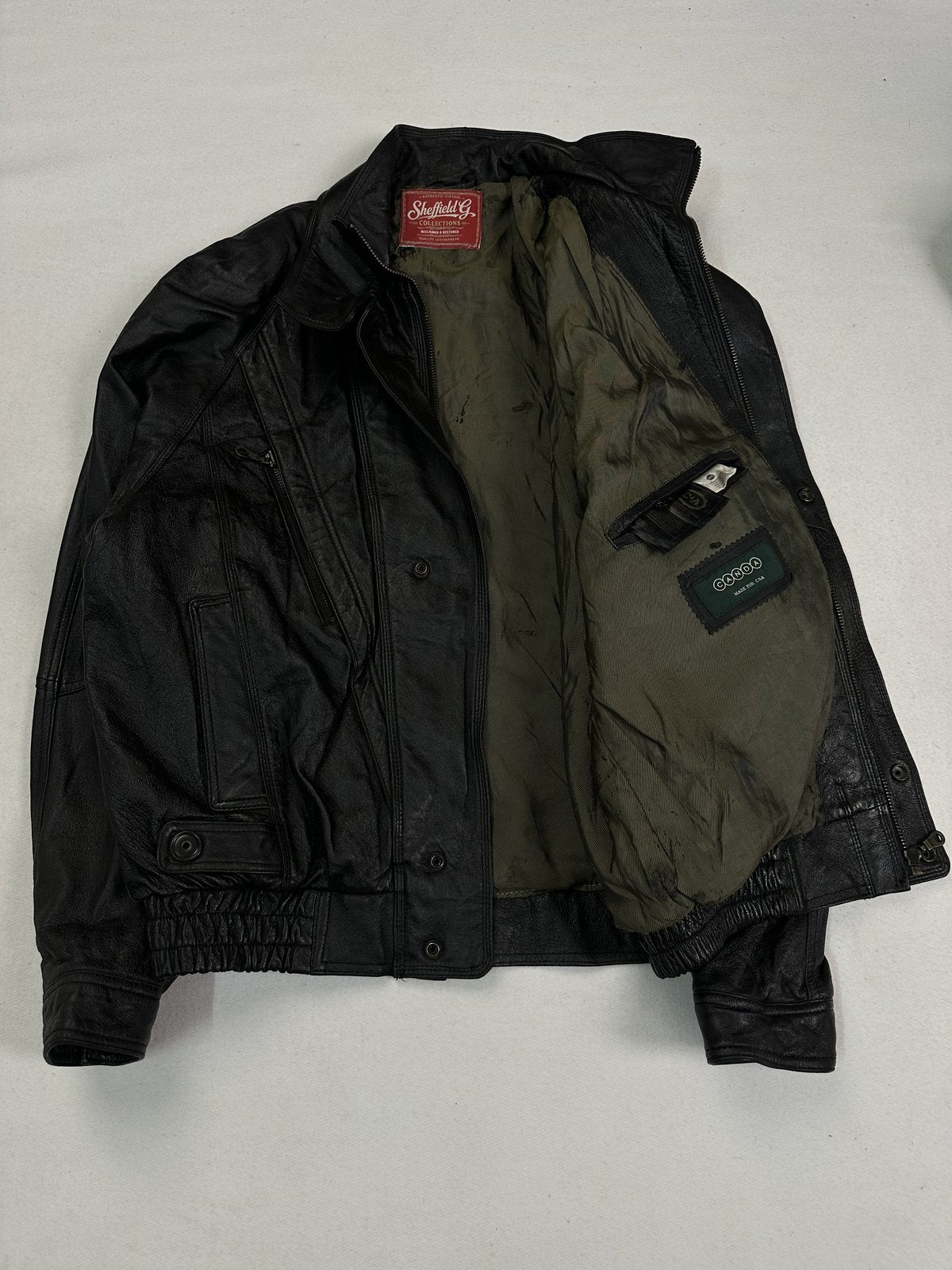 Interior of the size L bomber showing the full sweep of the olive green lining
