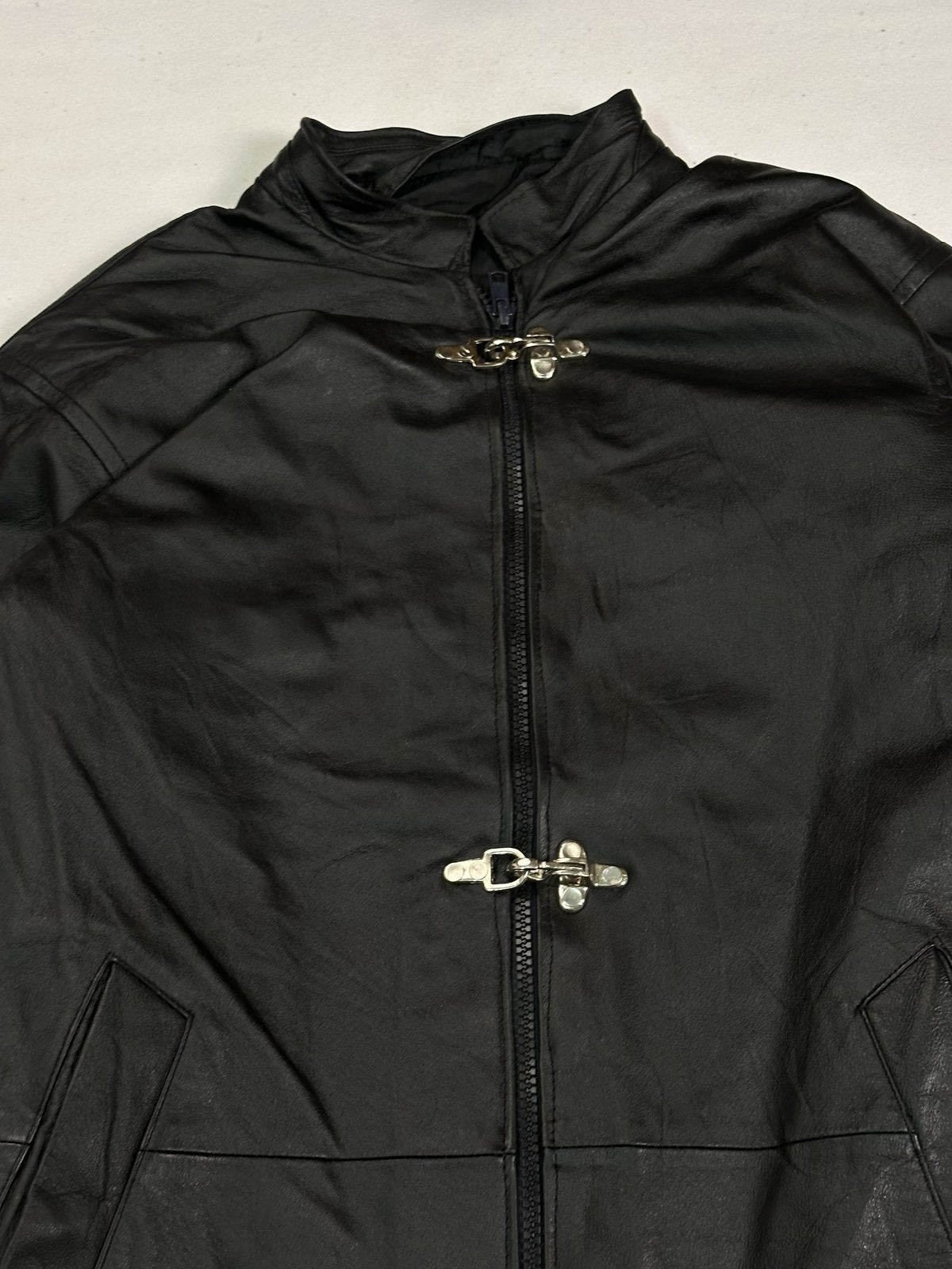 Close view of the stand collar with the top hook clasp above the centre zip
