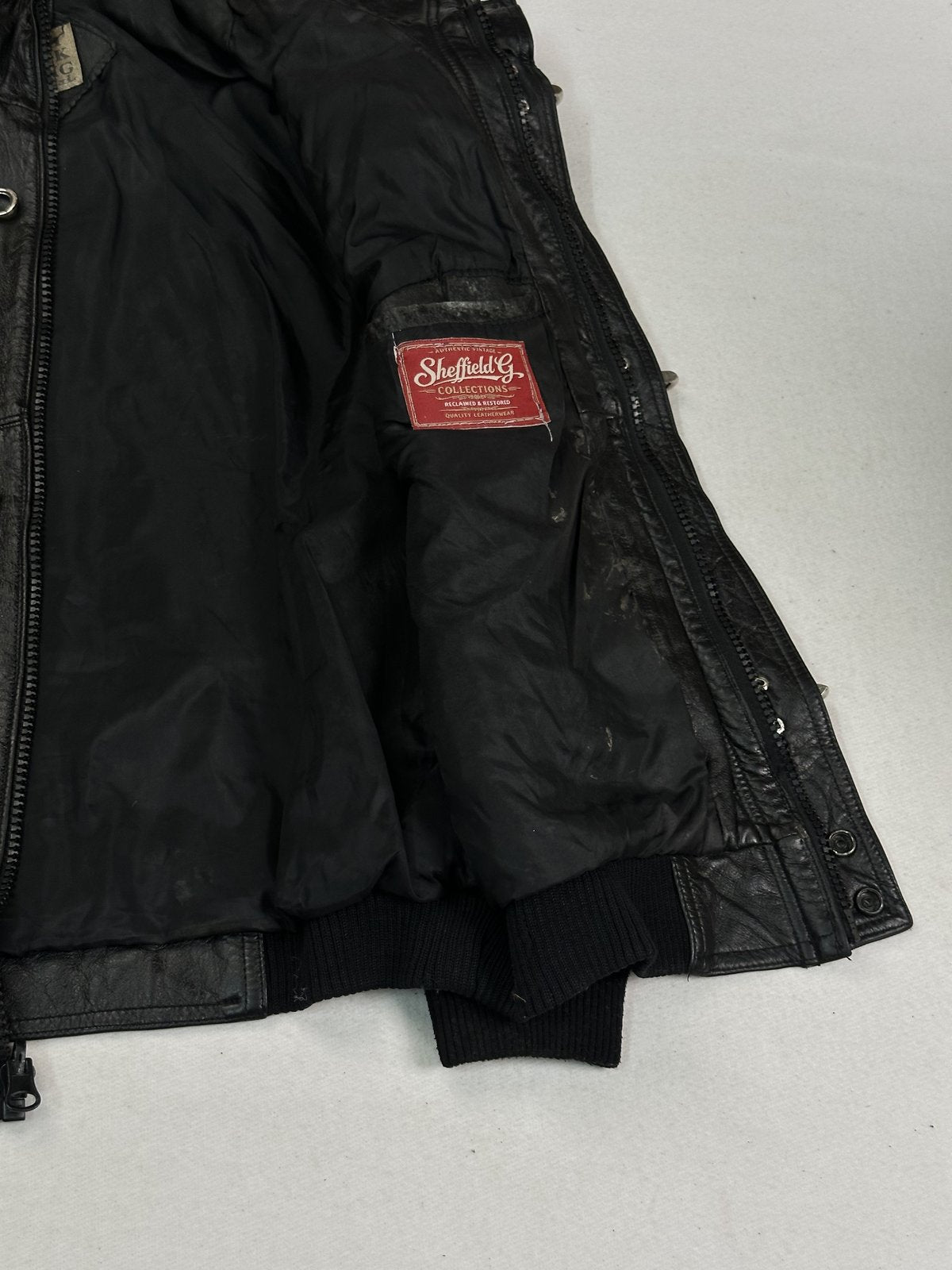 The size M black bomber, 24 inches long with a zipped front