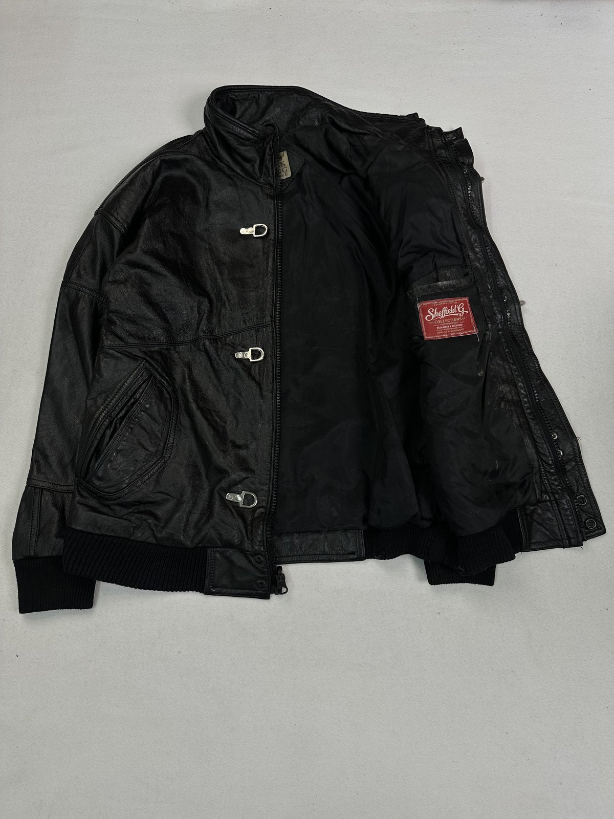 Black real leather bomber with rib trims at both the cuffs and the hem