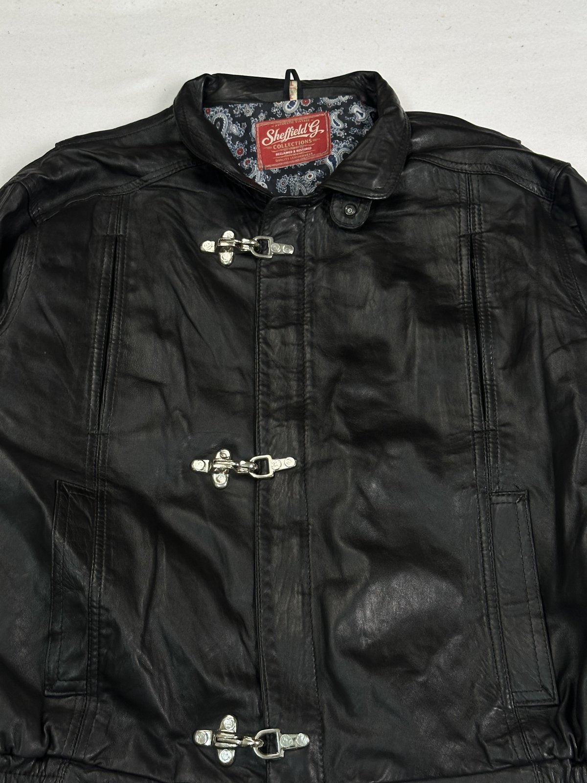 Close view of the stand collar with the paisley lining showing at the neck