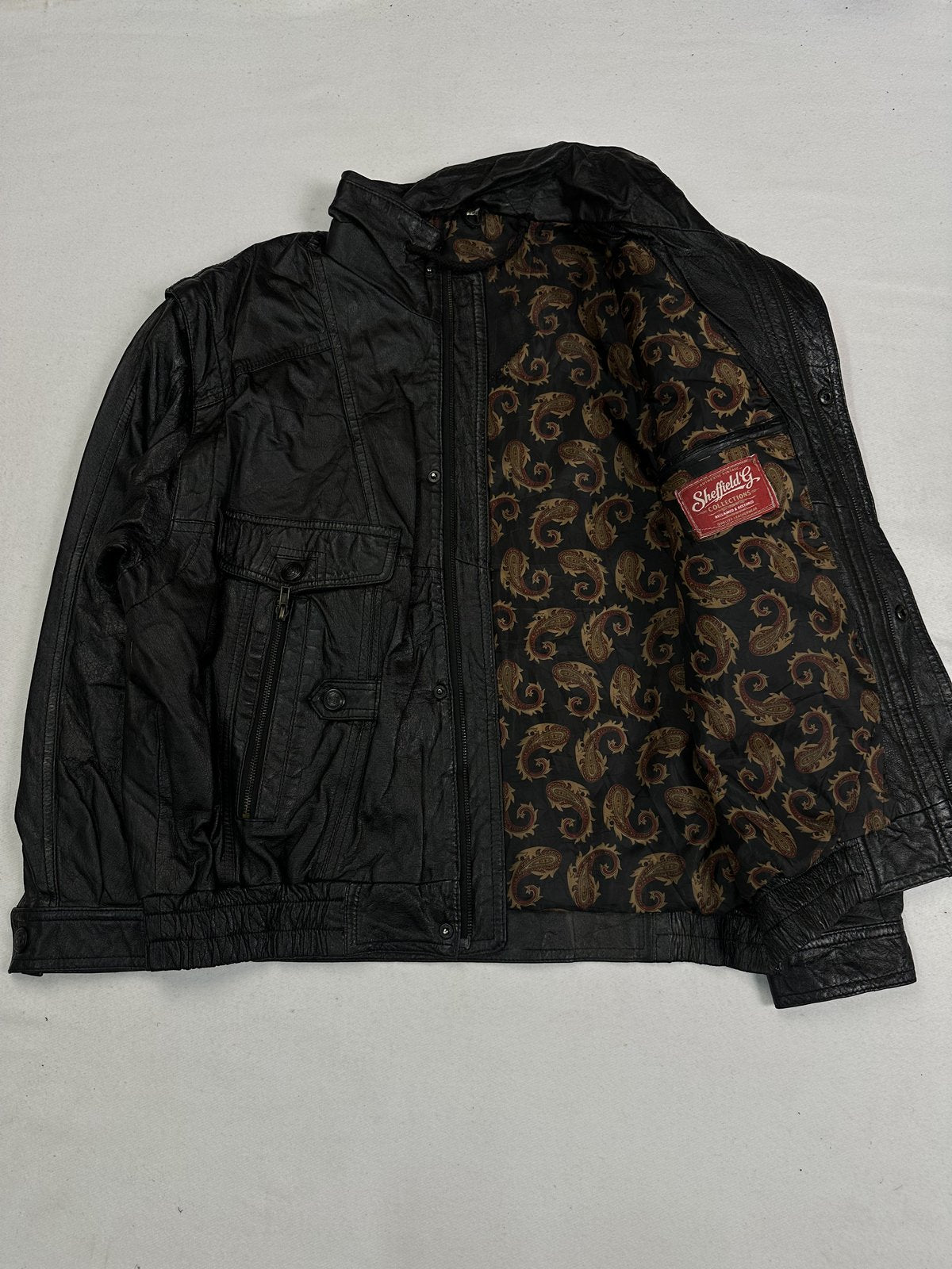 Four pocket black leather field jacket in size XL with a 22 inch shoulder