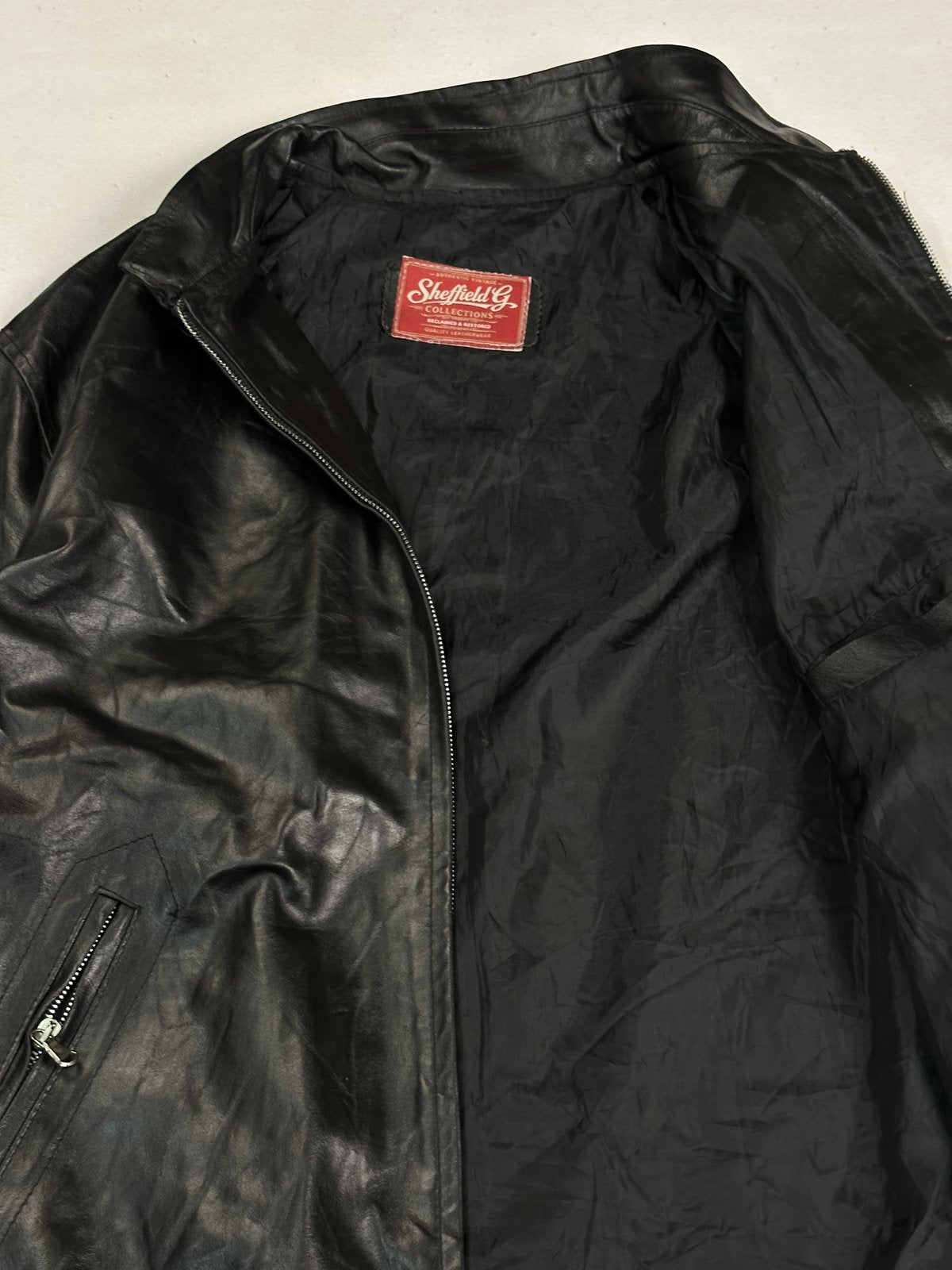 Slim cut black leather jacket in size L with a zipped front