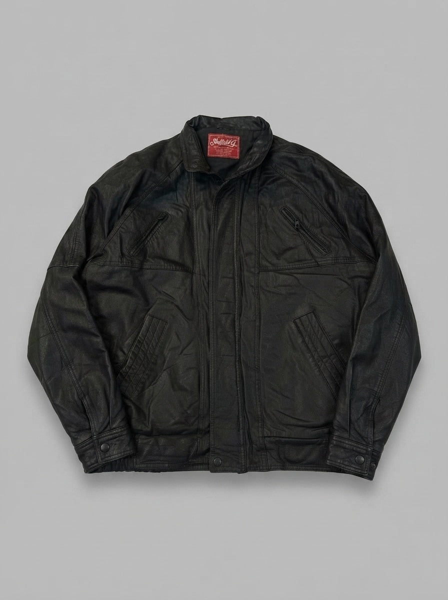 Black leather vintage jacket, size L, shown flat from the front. Chest Zip & Slash Pockets.
