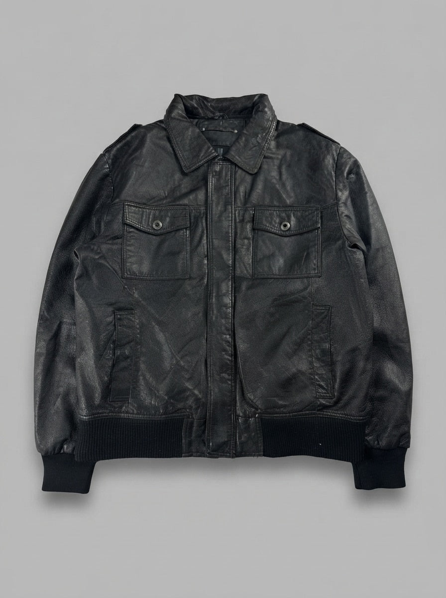 Black leather bomber jacket, size M, shown flat from the front. Flap Chest Pockets & Ribbed Hem.