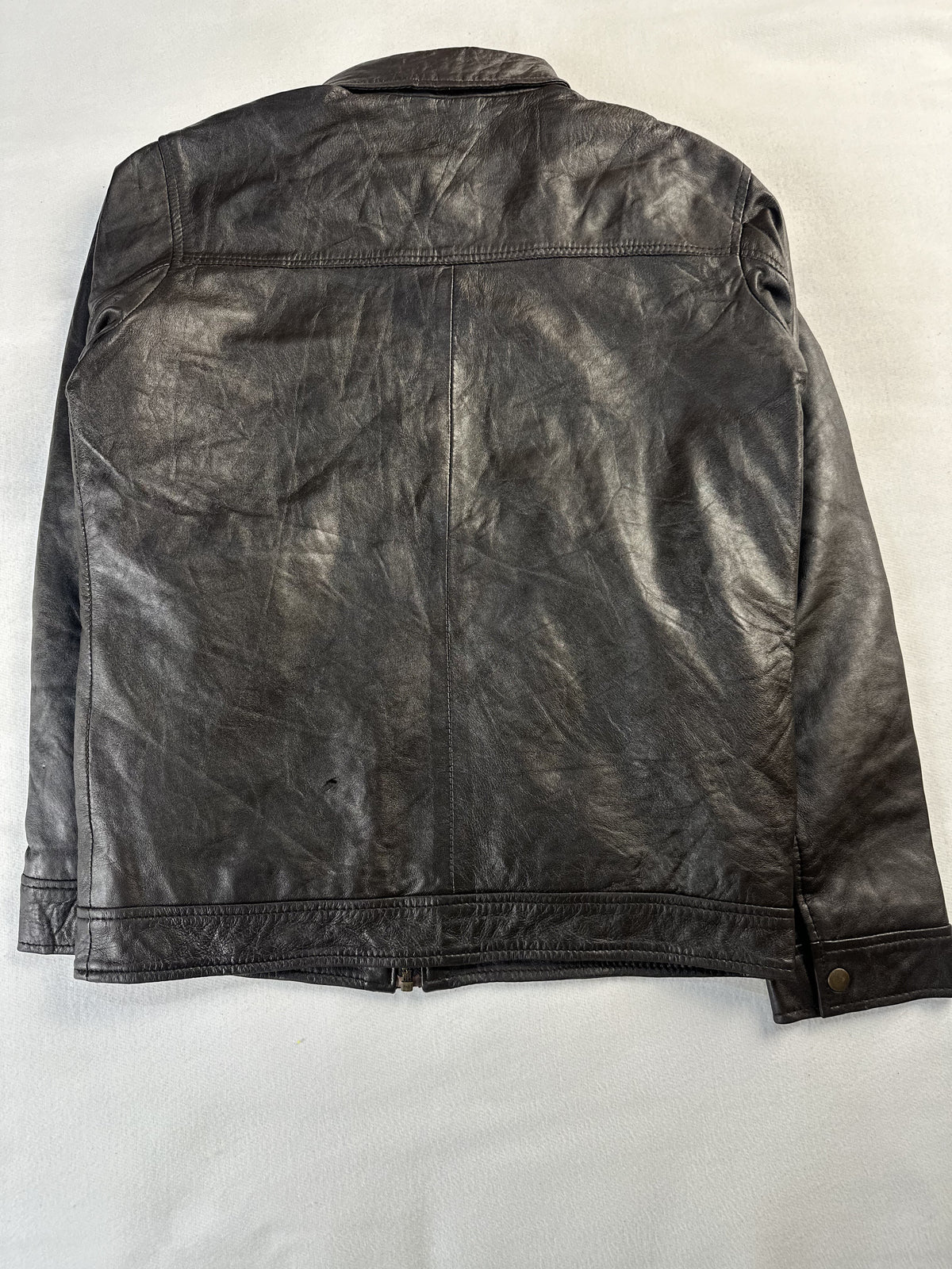 Back of the size M brown jacket laid flat, showing the plain panel and shoulder yoke seam