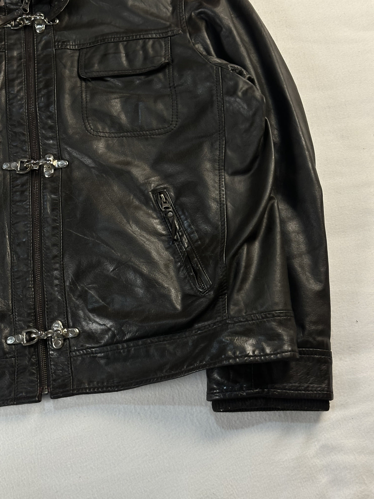Angled close view of the right chest pocket and the ribbed cuff turned back