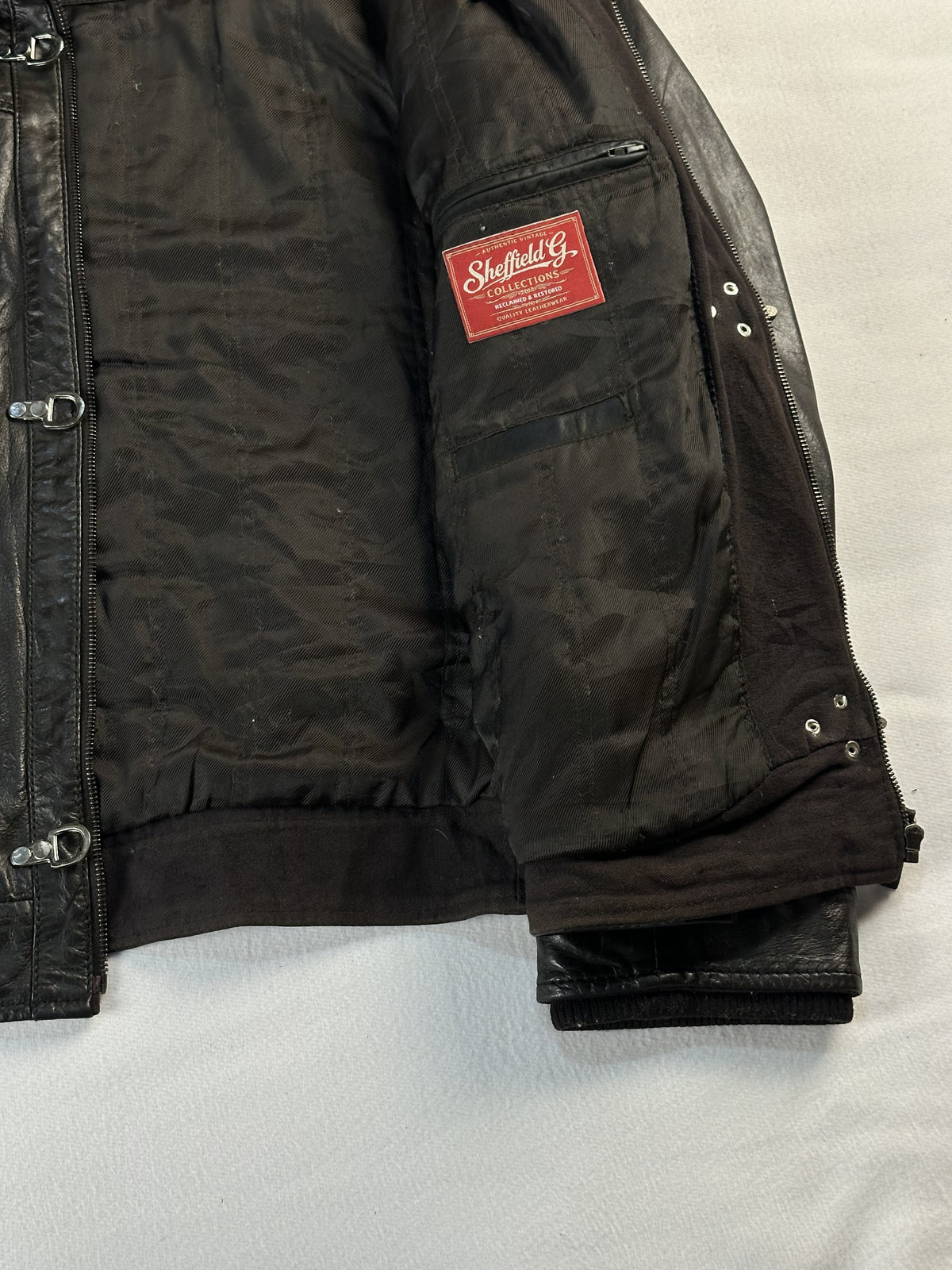 Dark lining held open inside the jacket, showing the zipped inside pocket