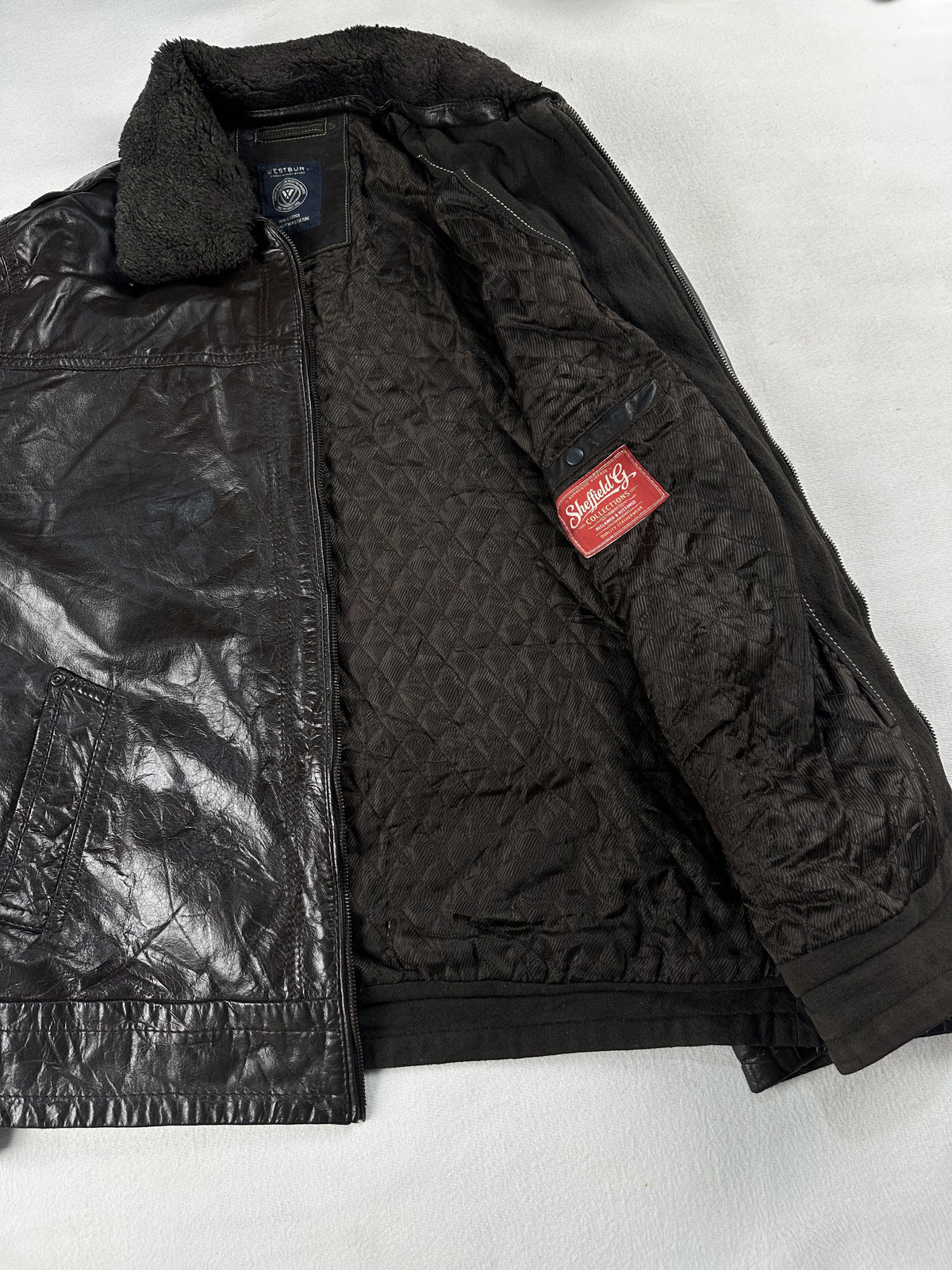 Brown cafe racer opened out flat to show the full quilted interior and collar backing