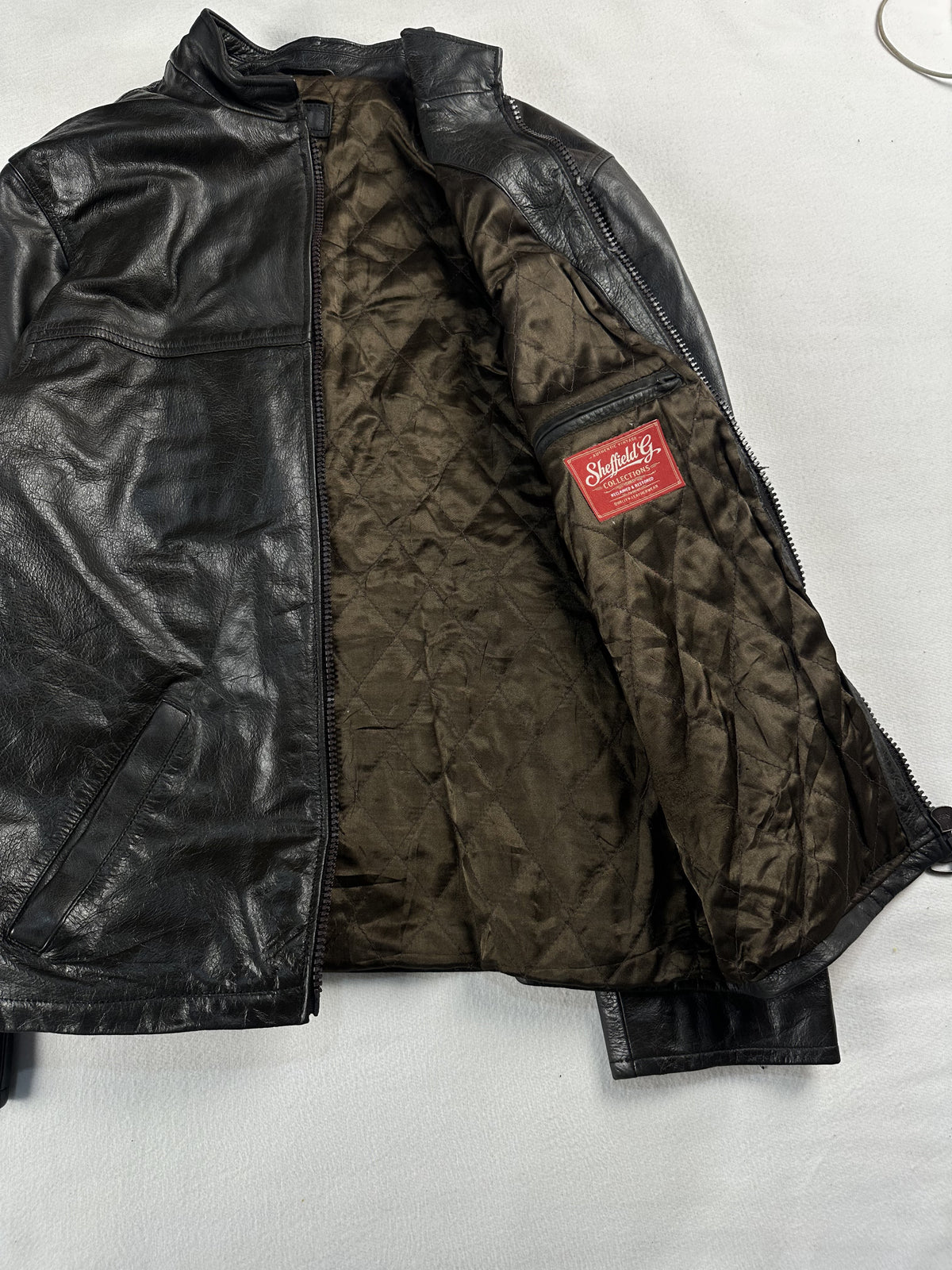 Quilted lined brown leather jacket in size L with an 18 inch shoulder