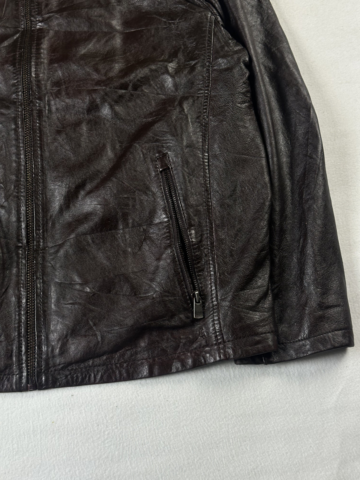 Lower right front with its slanted zip pocket and the main zip running down