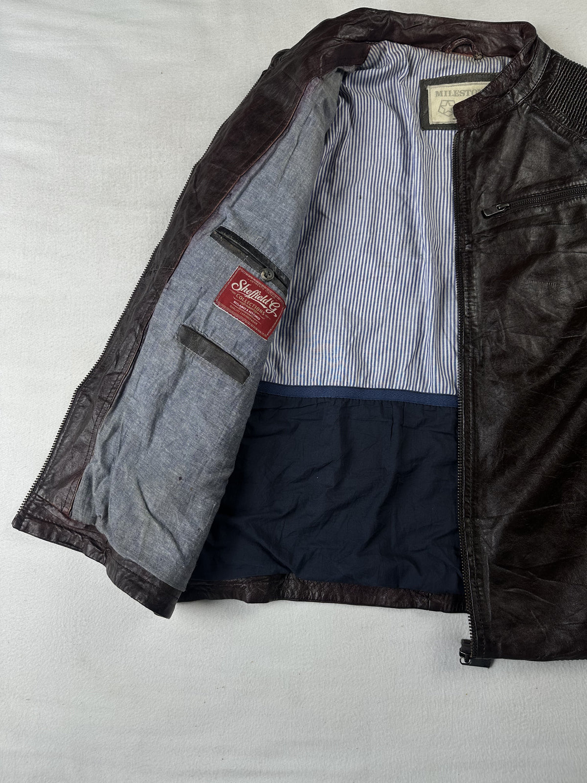 Cafe racer held open to show the striped lining and navy lower panel inside