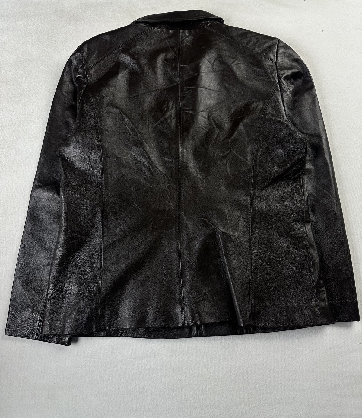 Back of the size M brown jacket laid flat, showing the blouson silhouette and straight hem