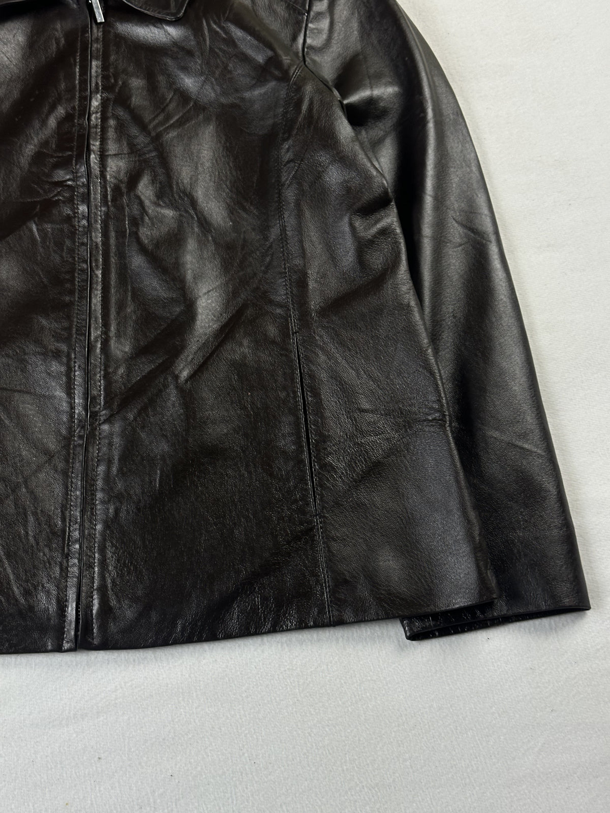 Lower right front with the centre zip running down to the straight hem
