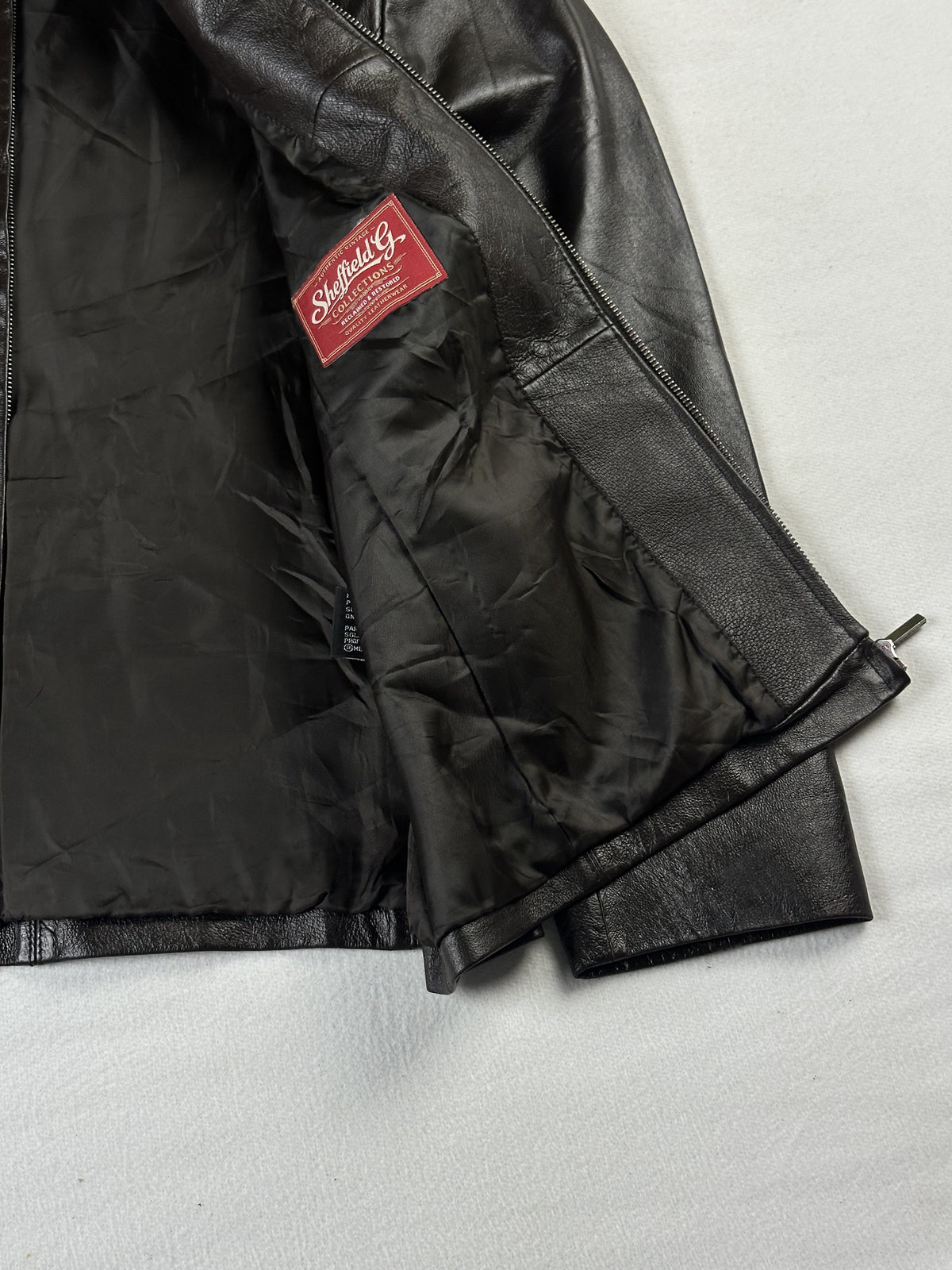 Smooth dark lining and interior label inside the brown jacket, held open