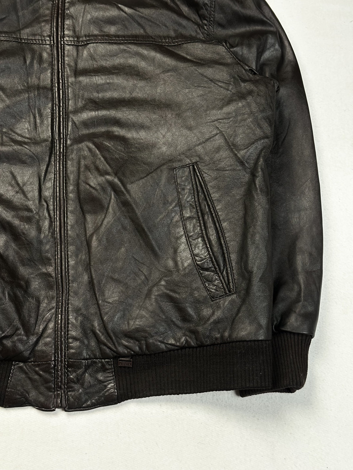 Ribbed knit cuff on the brown leather bomber