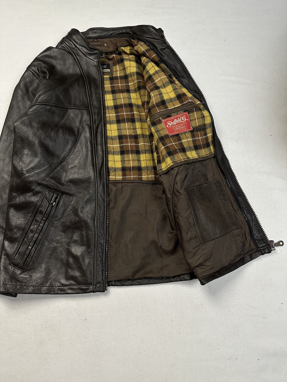 Brown cafe racer jacket opened out to show the tartan plaid lining running through the body