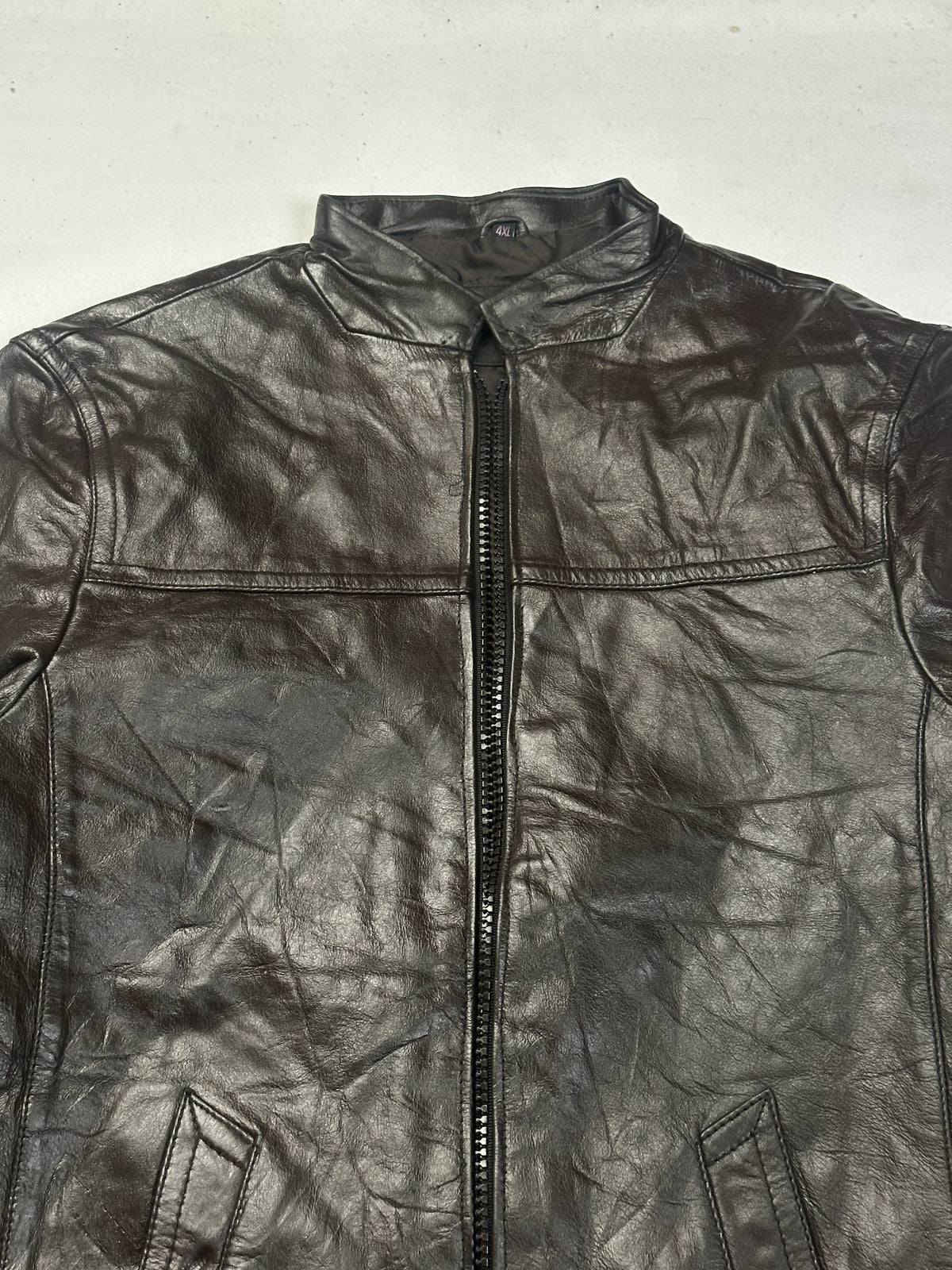 Close view of the band collar and the chest seams running out from the zip