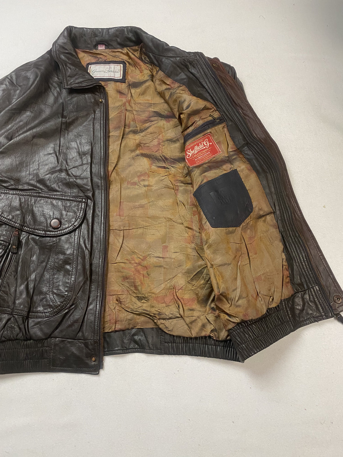 Mottled tan lining inside the brown jacket, held open to show the interior pocket
