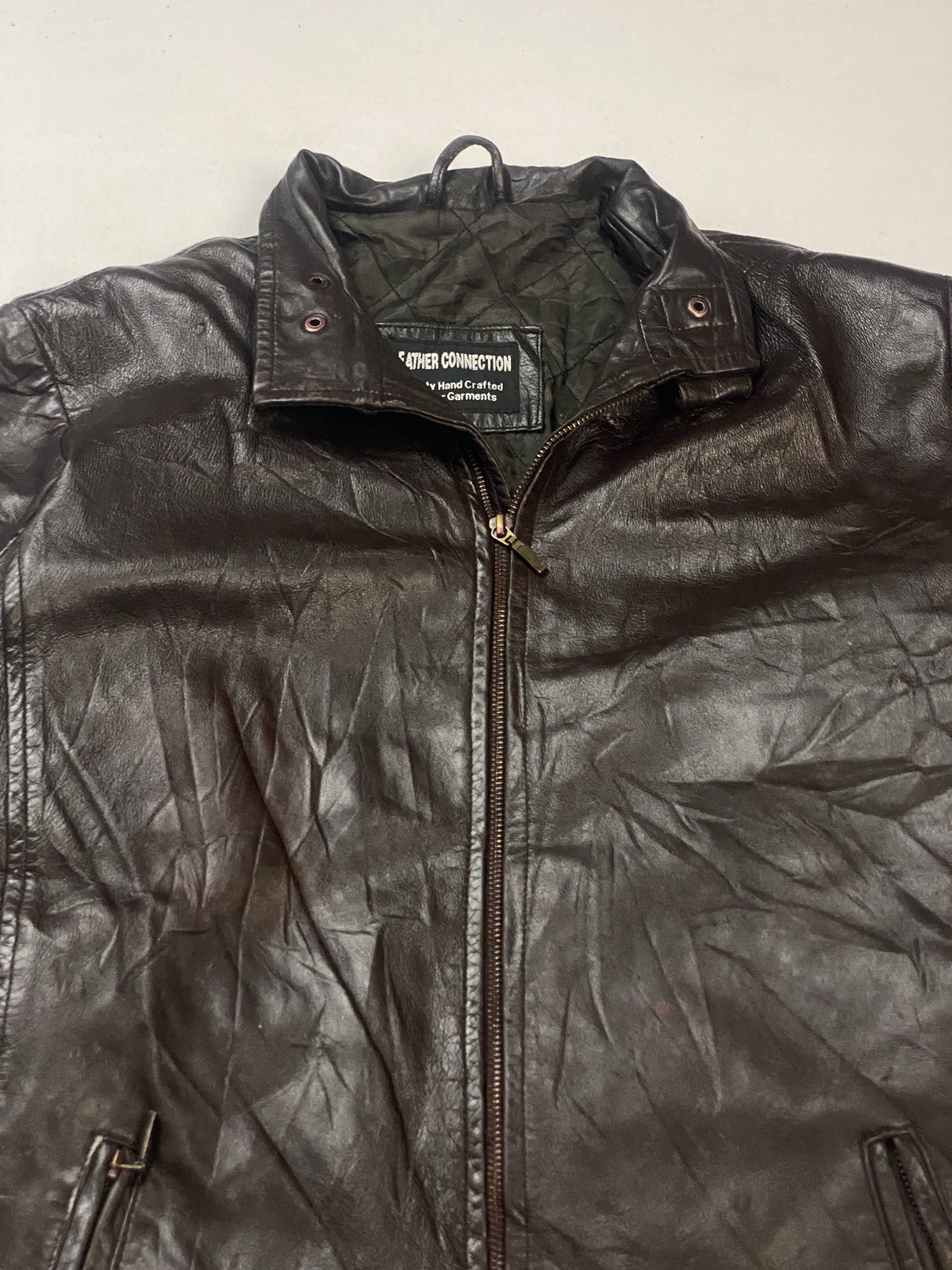 Band collar, neck snap and the top of the front zip on this vintage brown jacket