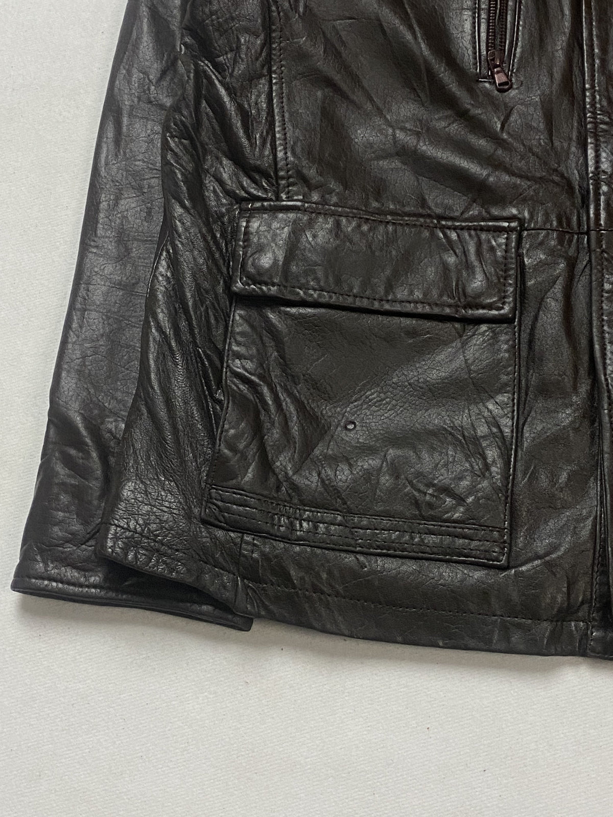 Herringbone tweed lining inside the brown leather field jacket