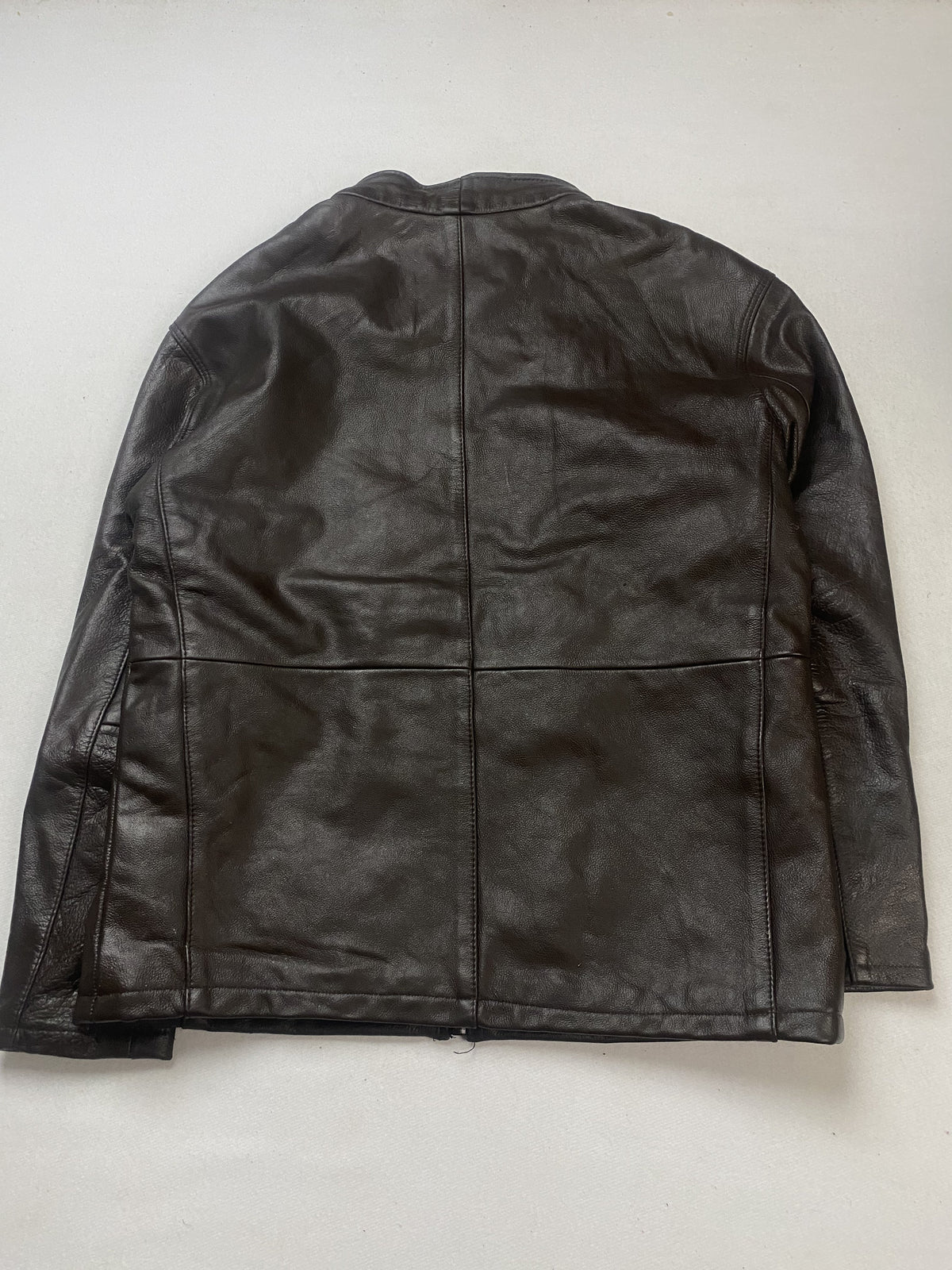 Welt hip pocket cut into the brown leather of the jacket