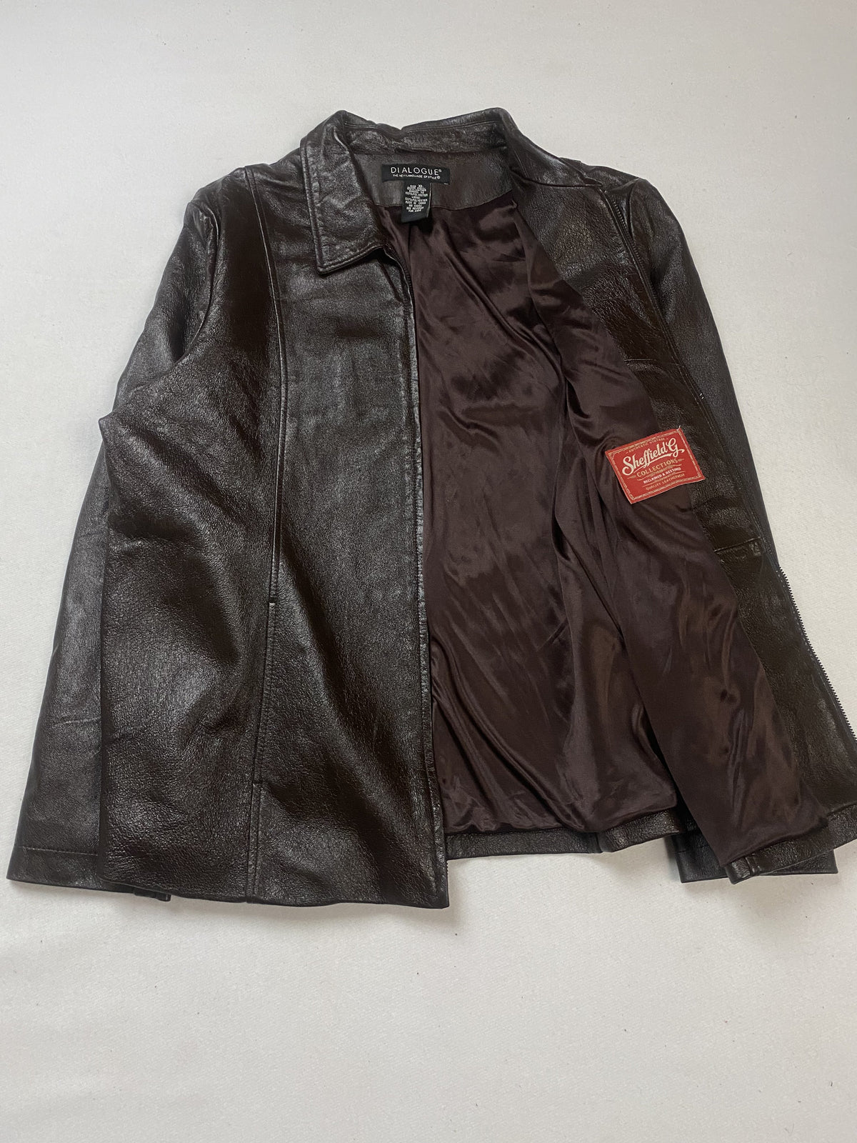 Brown satin lining inside the jacket, held open to show the interior