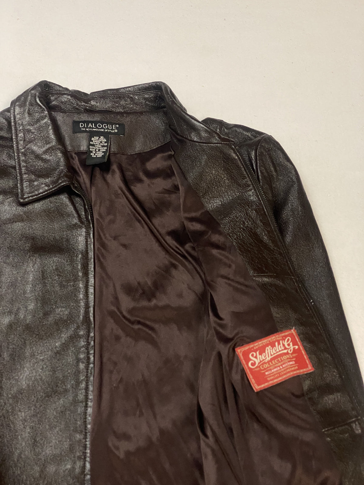 Detail of the smooth lining and stitched inner labels beside the collar
